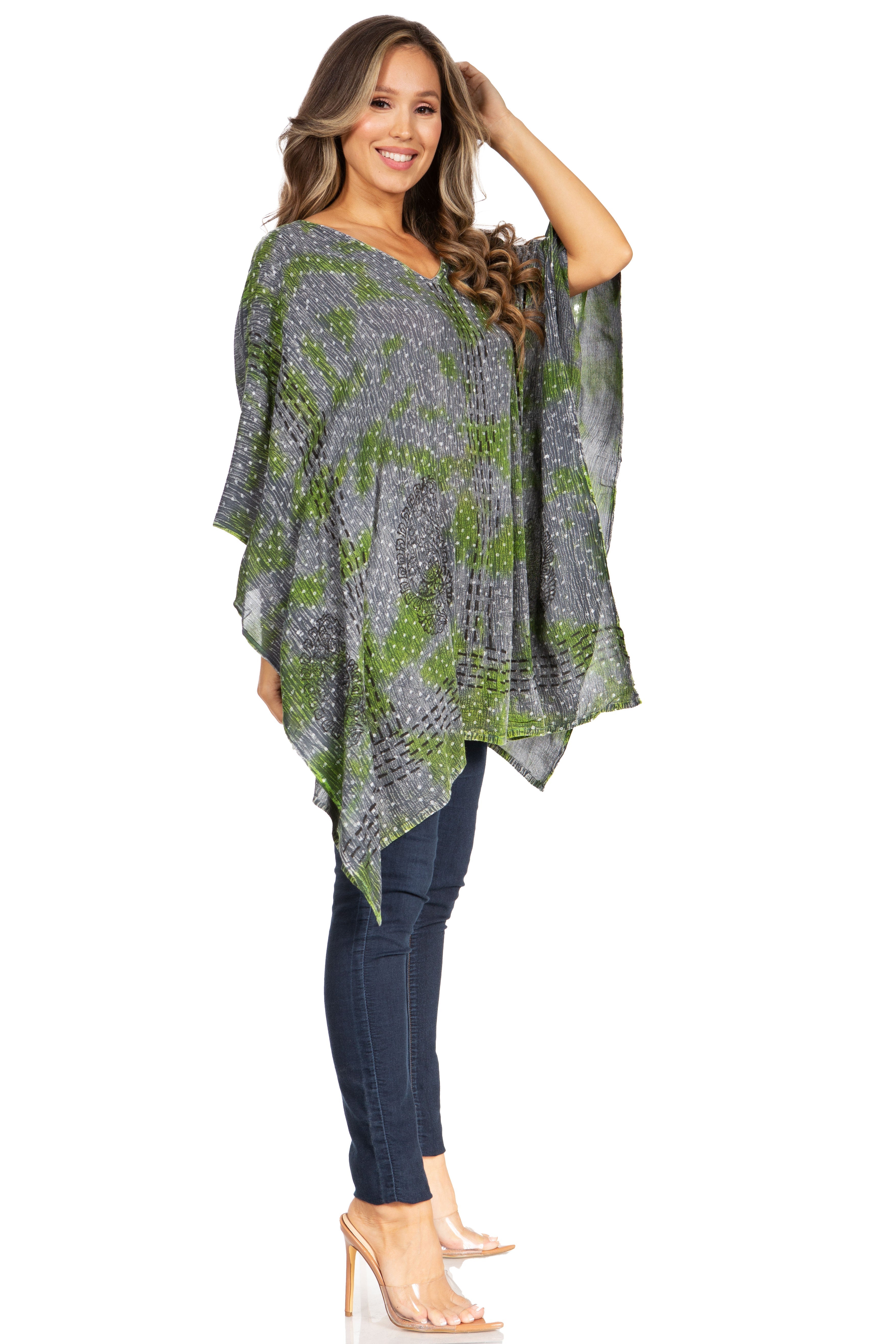 Woman wearing a patterned poncho over a plain background