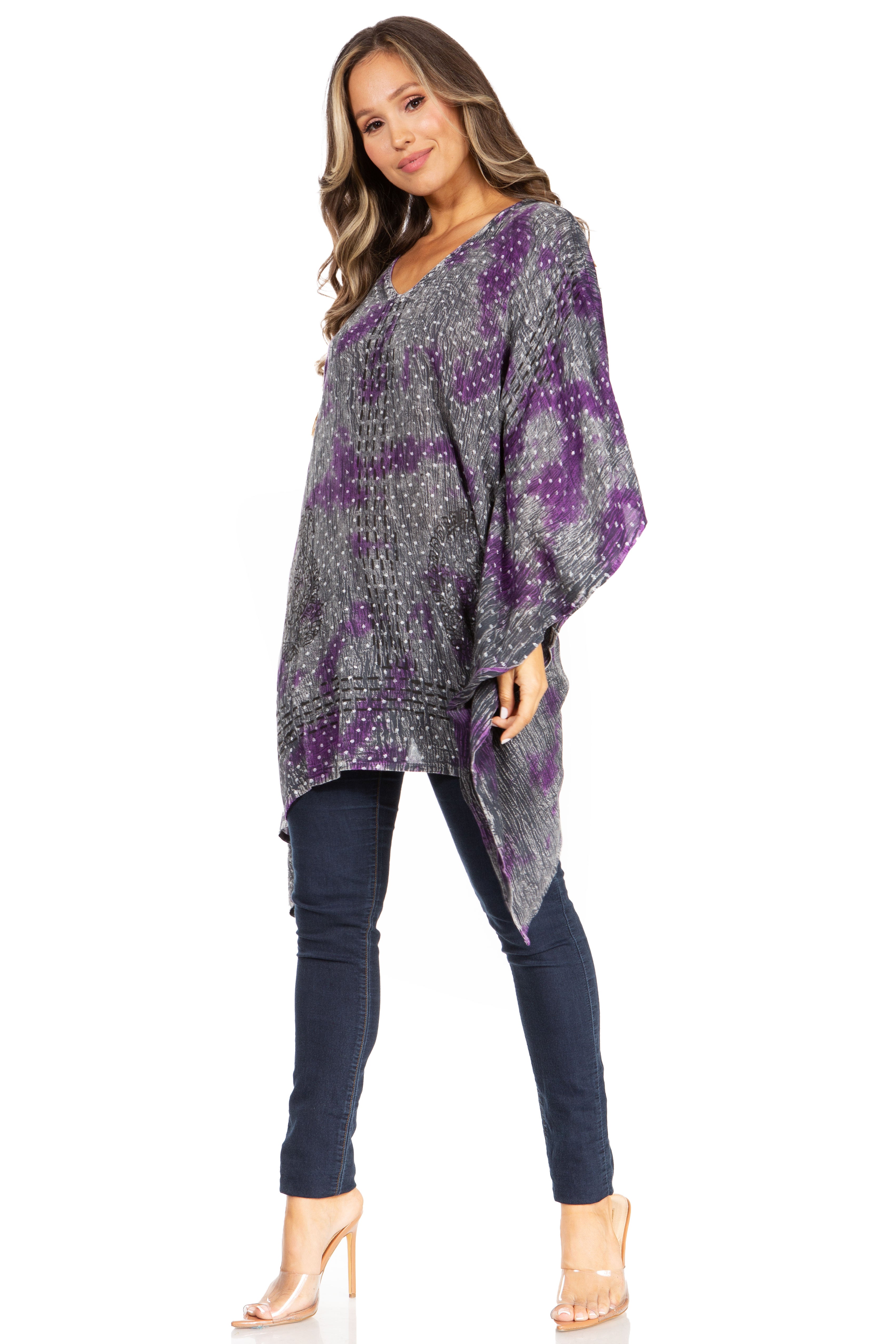 Woman wearing a purple and gray patterned poncho on a white background