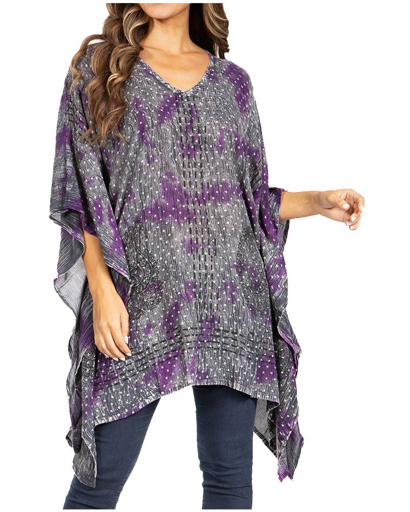 Woman wearing a purple and gray patterned poncho on a white background