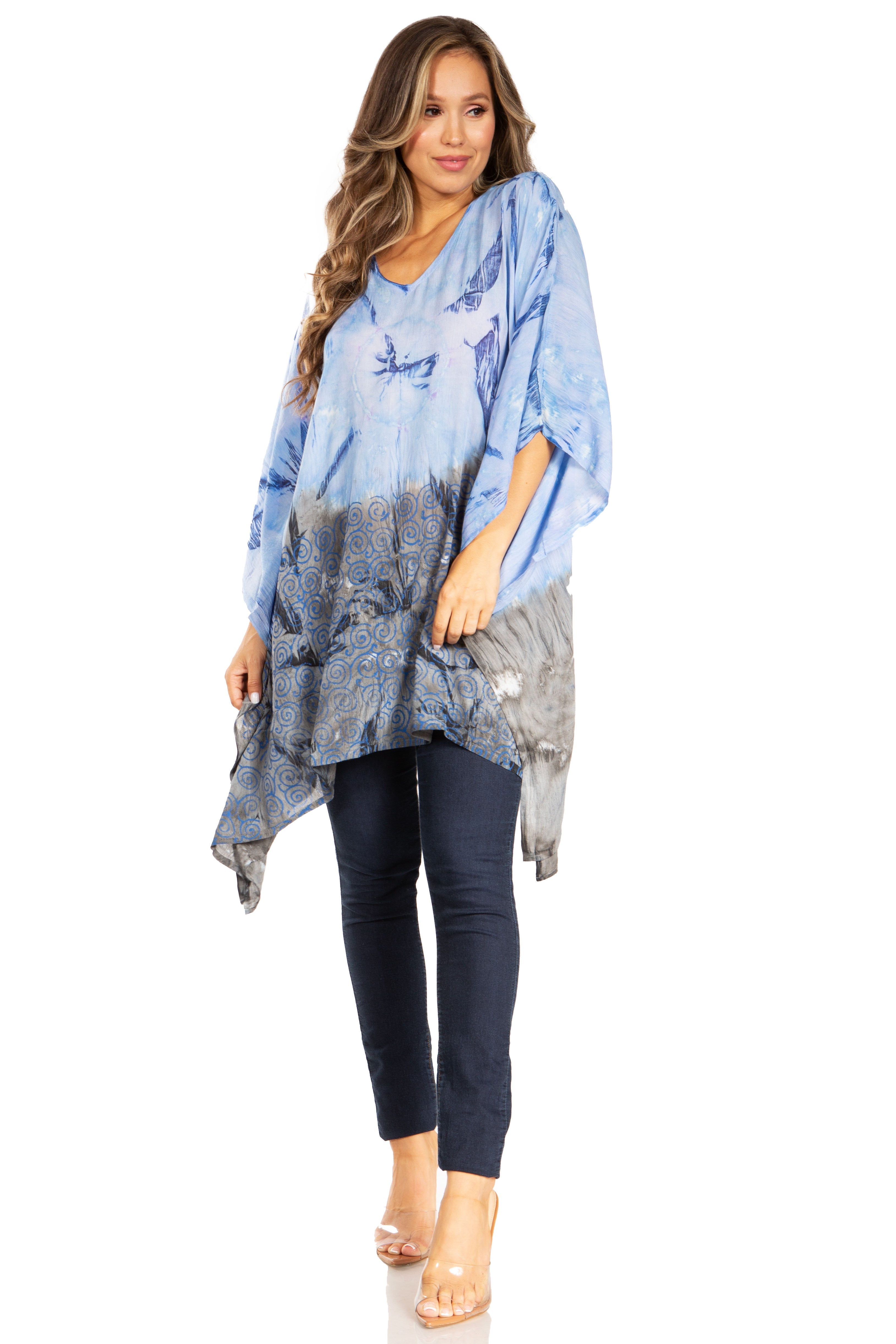 Woman wearing a blue patterned top and black pants on a white background