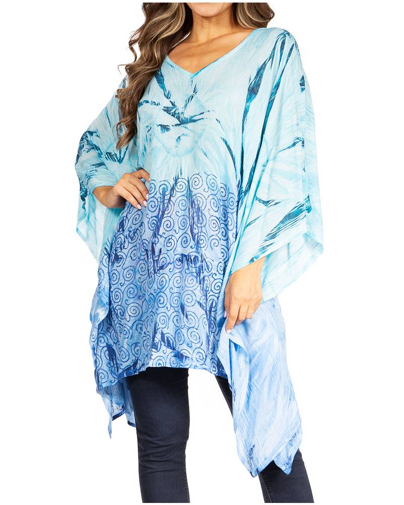 Woman wearing a blue patterned poncho on a white background