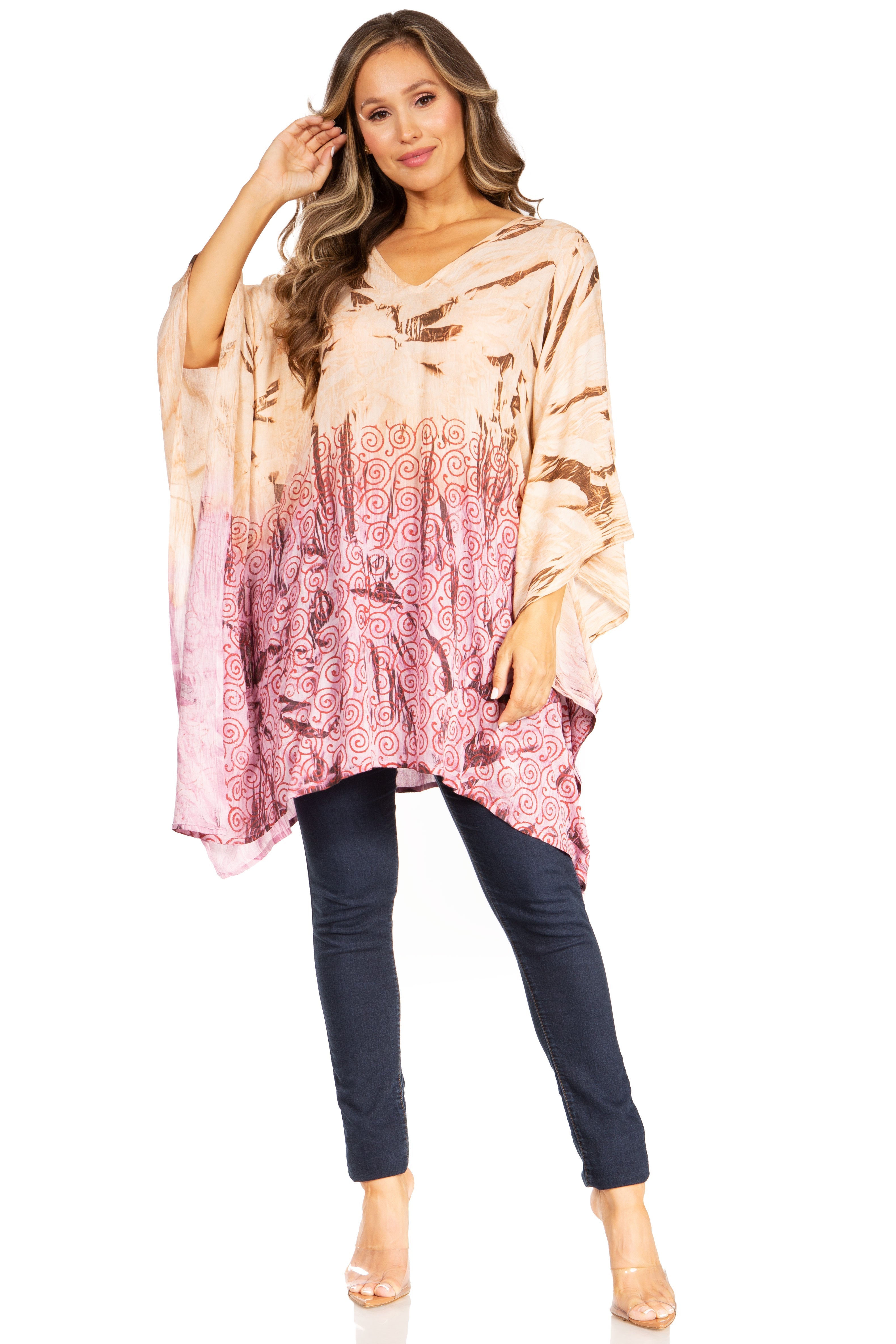 Woman wearing a tie-dye top and dark pants on a white background