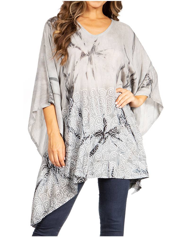Woman wearing a gray patterned poncho over a white background