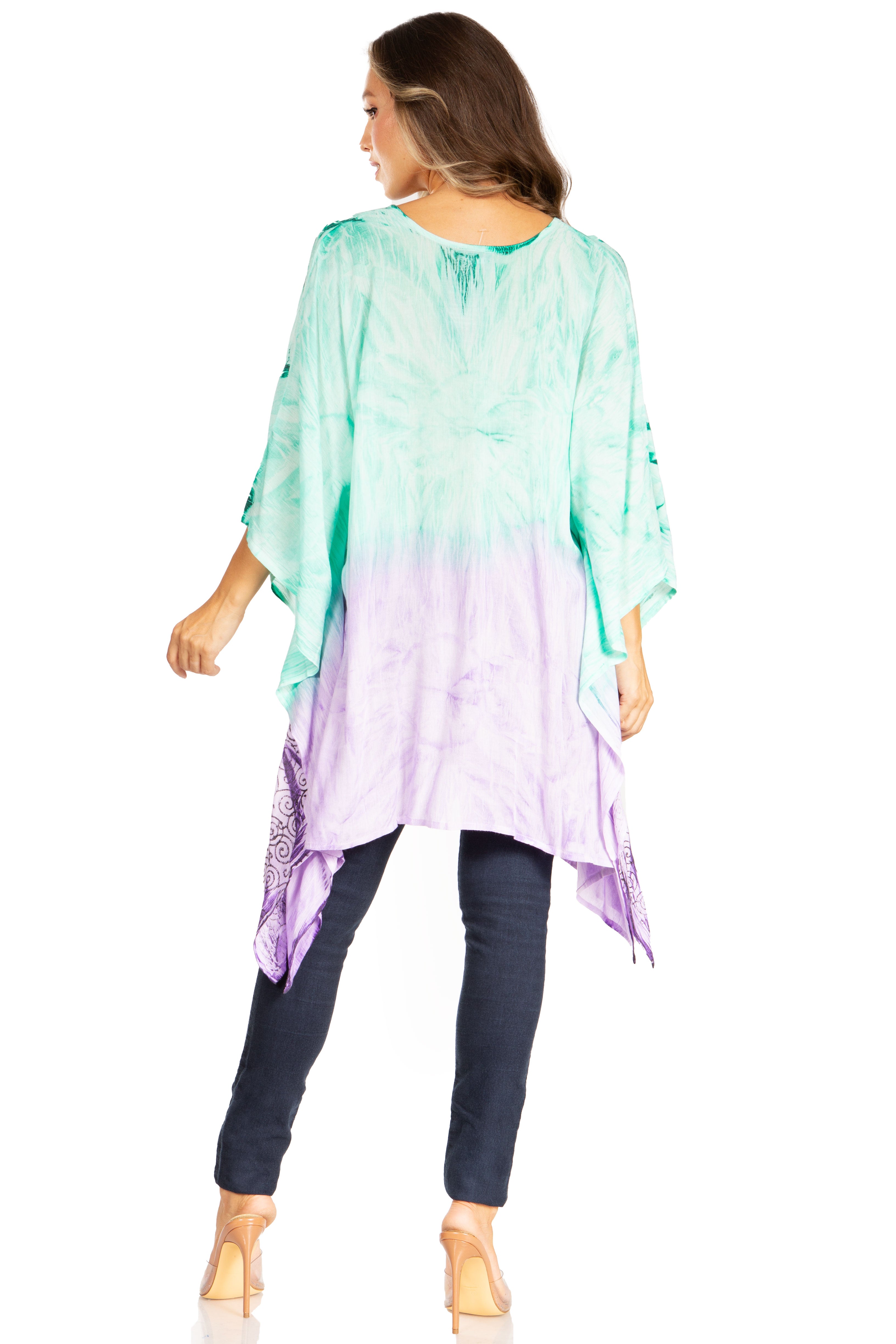 Woman wearing a colorful tie-dye shirt with a gradient from green to purple.