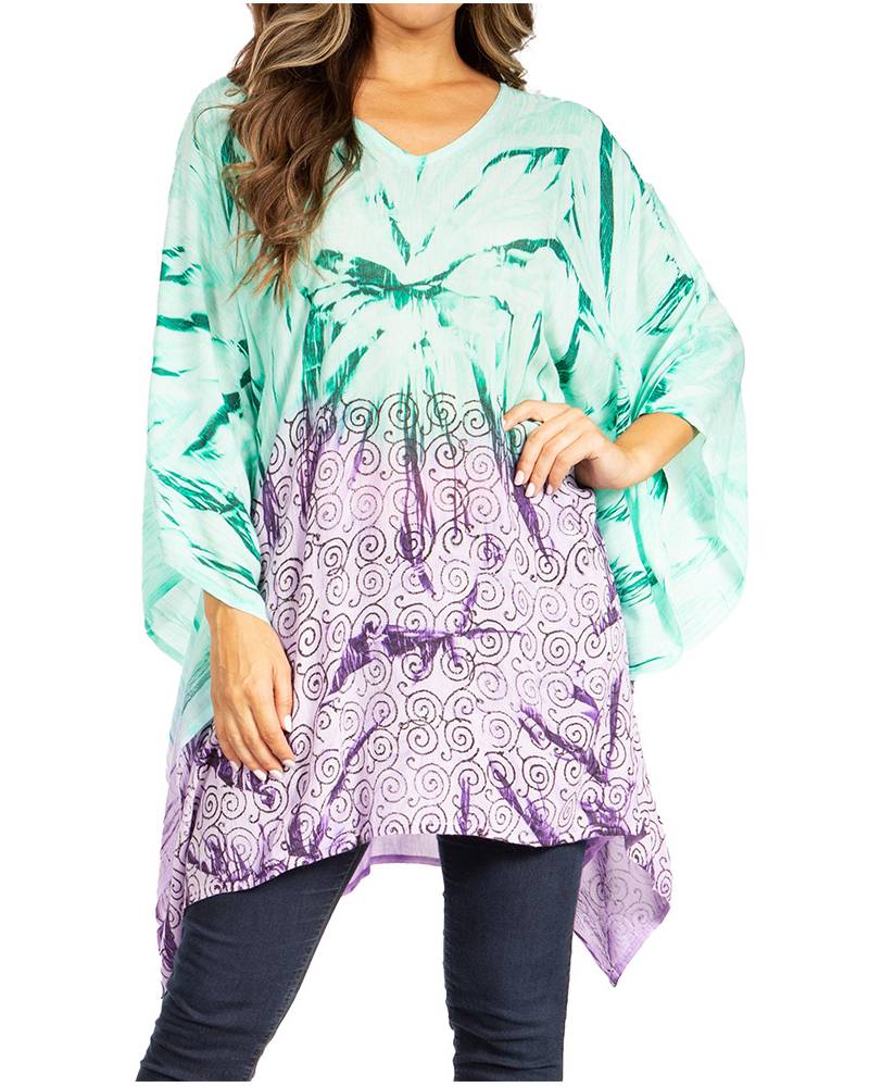 Woman wearing a turquoise and purple patterned top with a white background