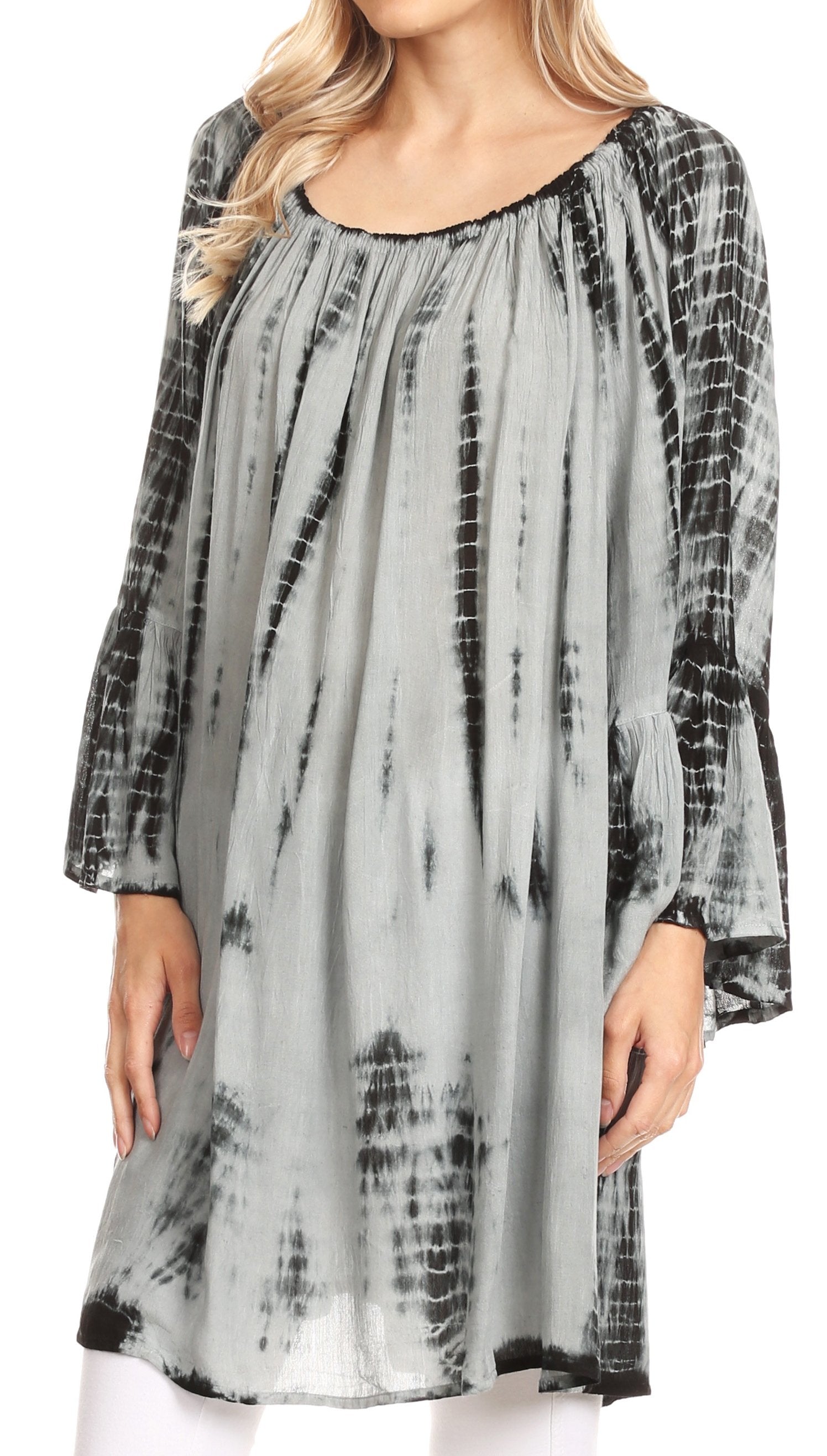 Woman wearing a gray tie-dye dress with black accents on a white background