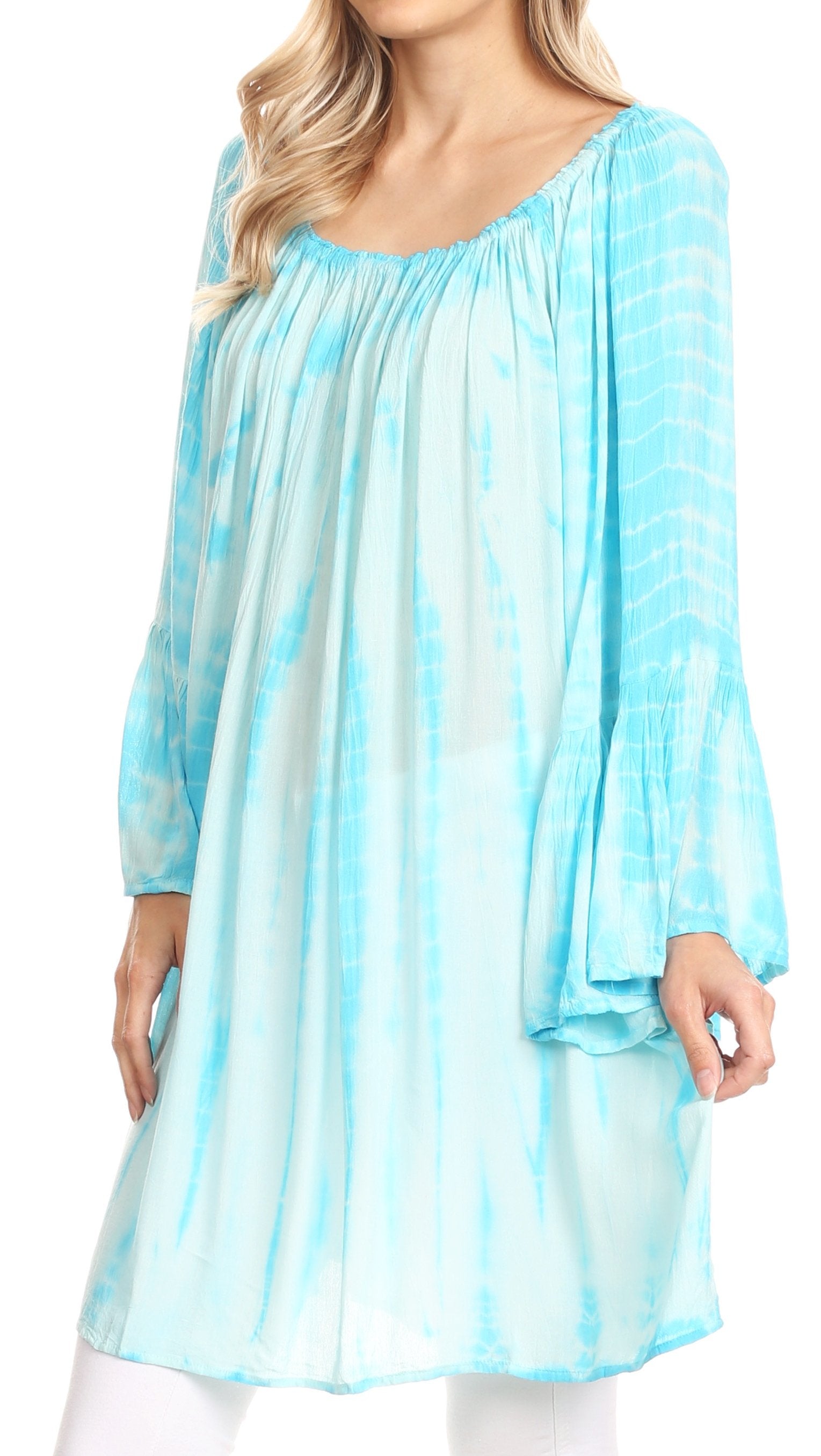 Woman wearing a light blue tie-dye dress against a white background