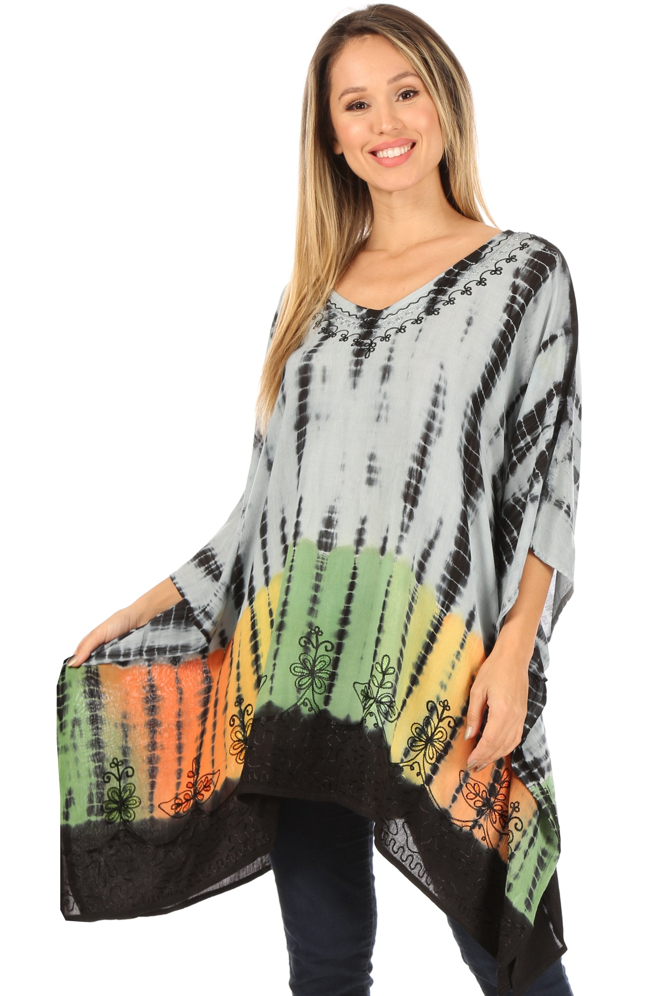 Woman wearing a tie-dye poncho with colorful patterns on a white background