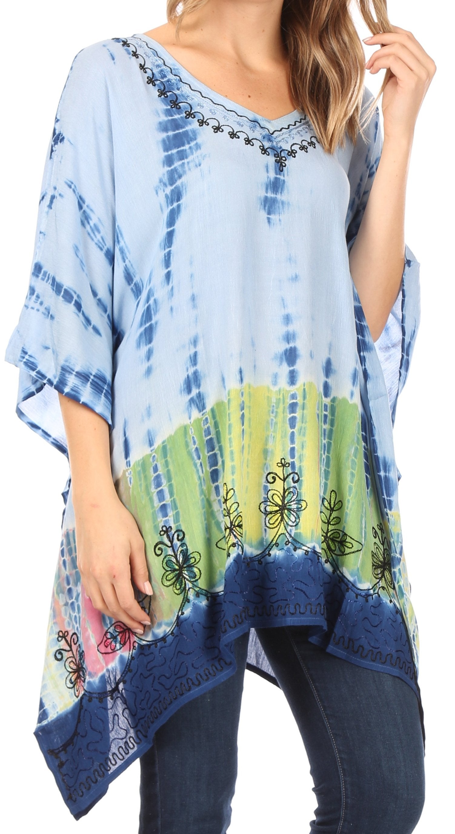Woman wearing a blue tie-dye poncho with colorful patterns on a white background