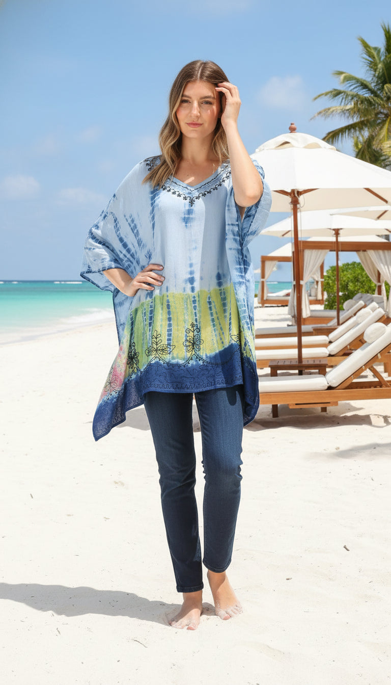 Woman wearing a blue tie-dye shirt with colorful patterns on a white background