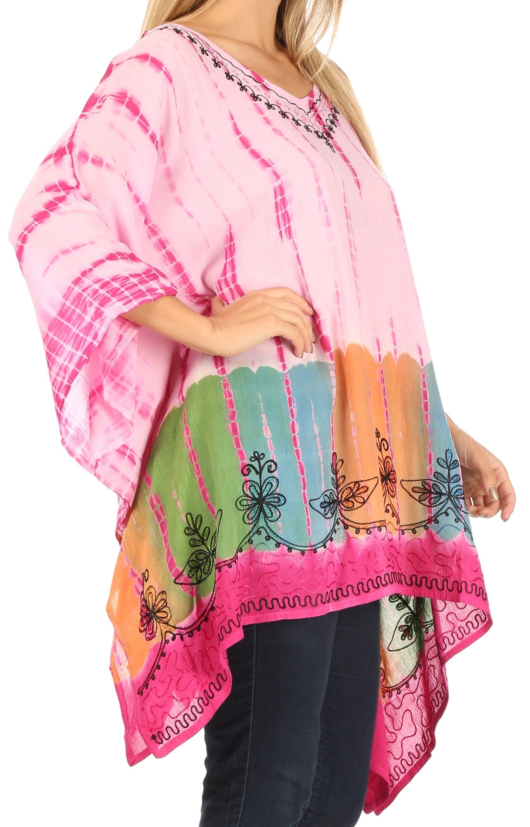 Woman wearing a colorful, patterned pink and multicolor top with a white background