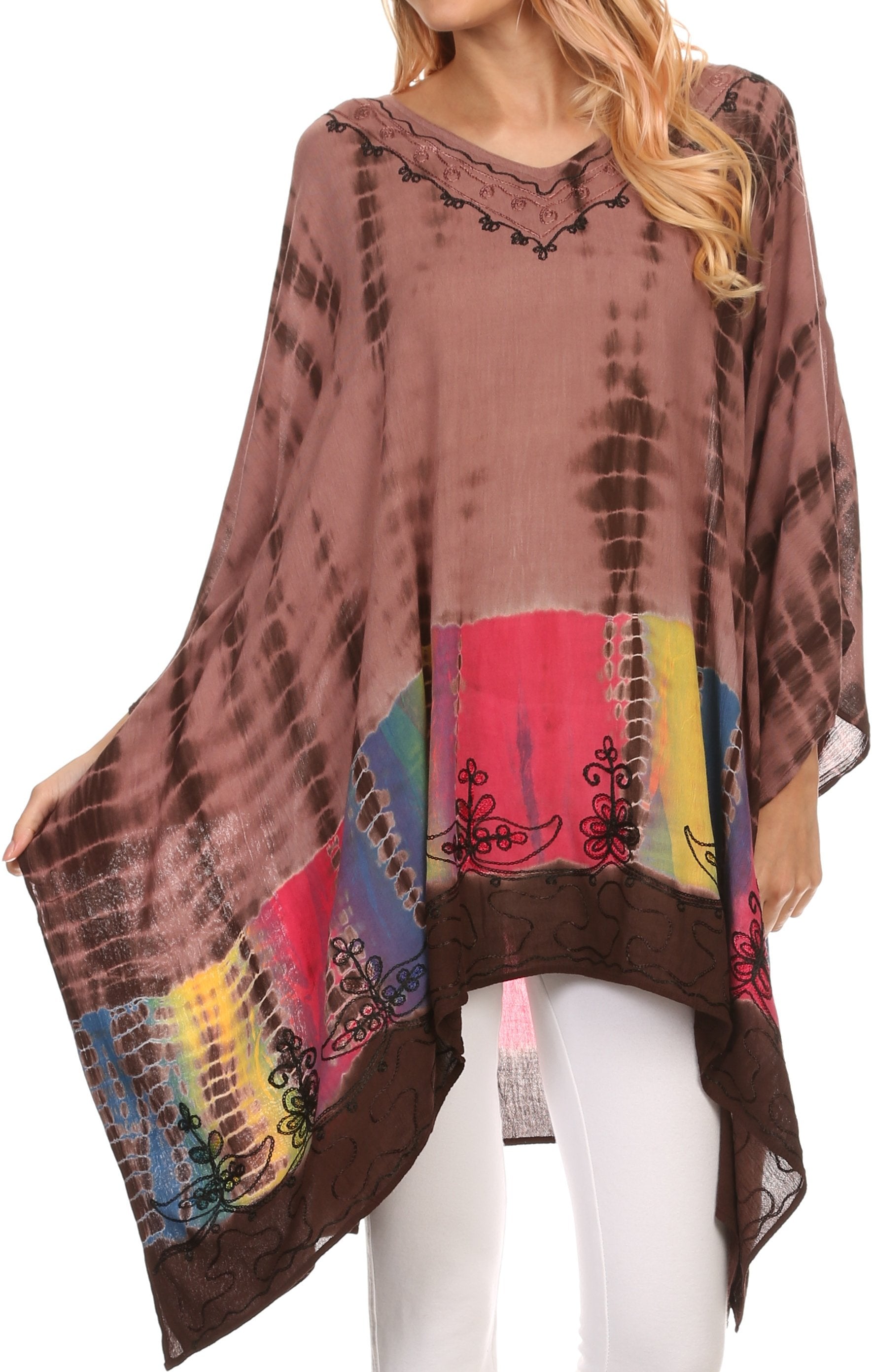 Woman wearing a colorful tie-dye poncho with a patterned design on a white background