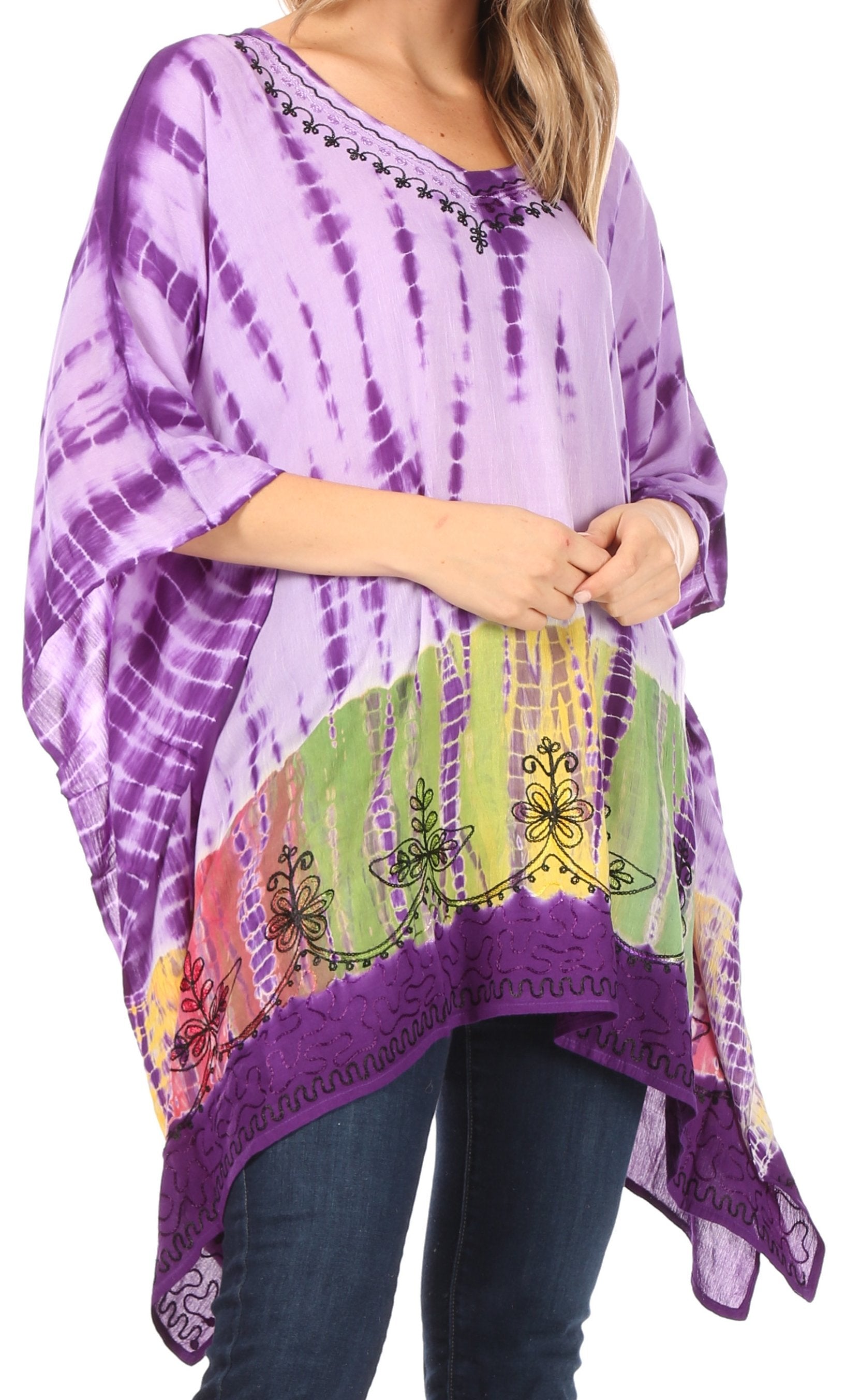 Person wearing a purple tie-dye poncho with colorful patterns on a white background