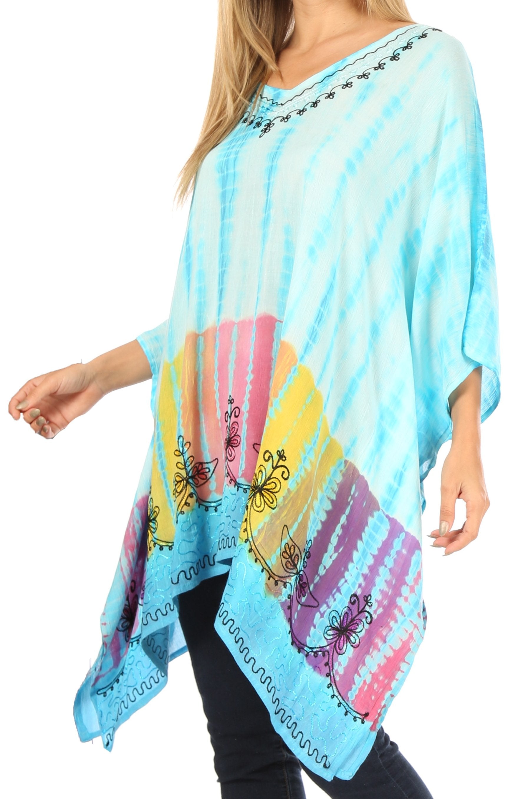 Woman wearing a colorful tie-dye poncho with butterfly designs on a white background
