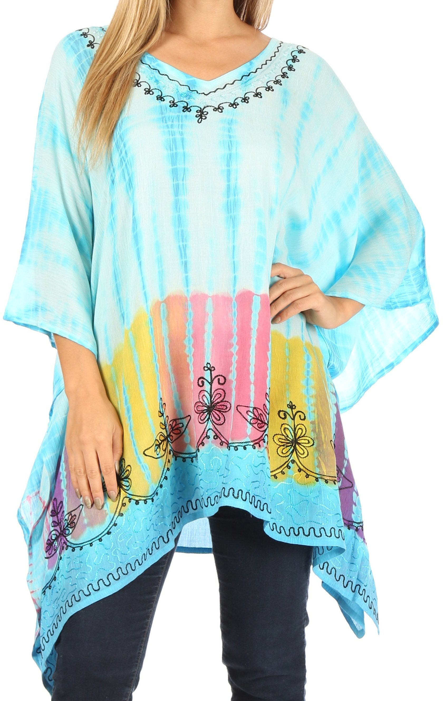 Woman wearing a colorful tie-dye poncho with butterfly designs on a blue background