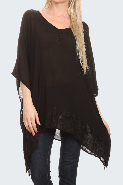Black poncho worn by a person on a white background
