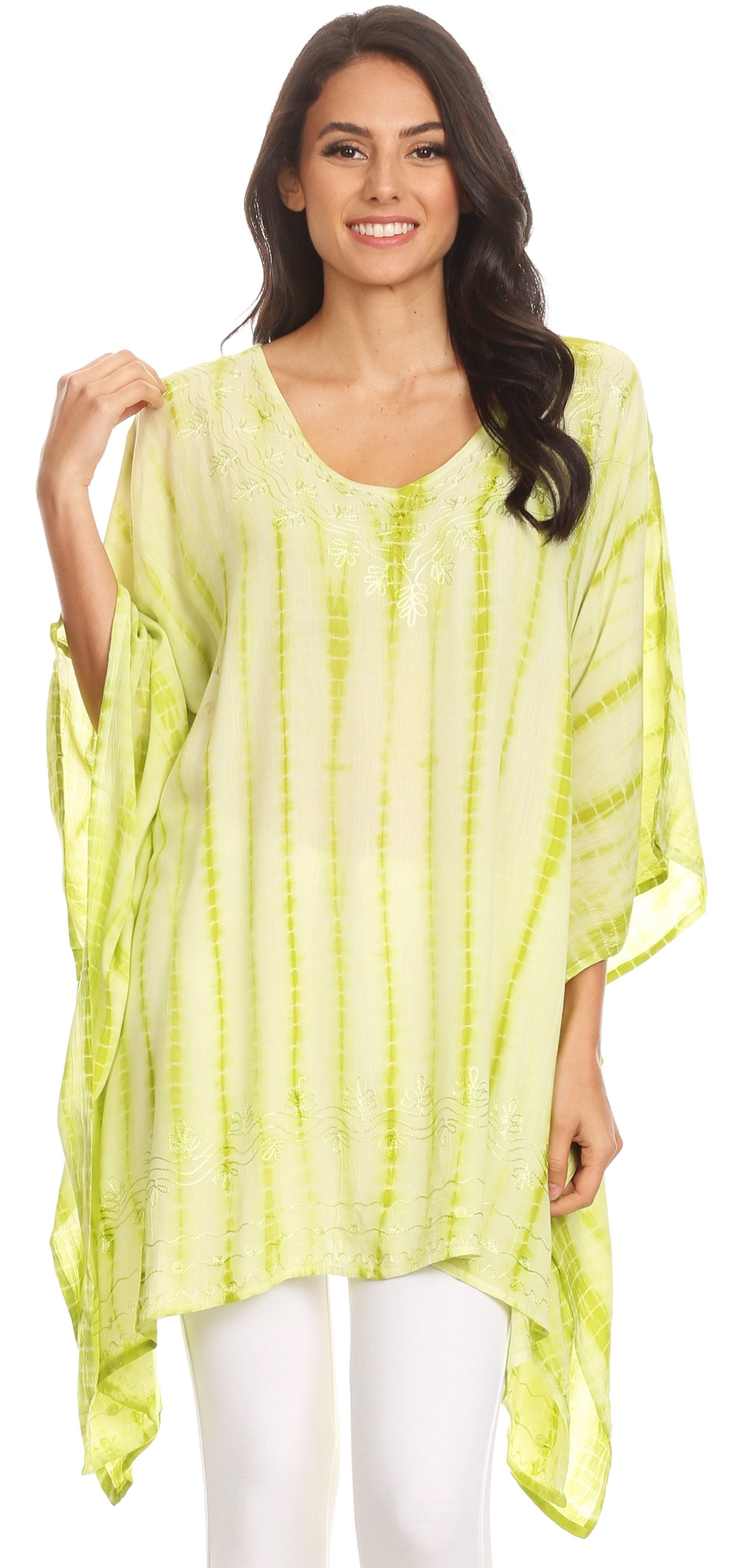Woman wearing a light green tie-dye caftan over white pants on a white background