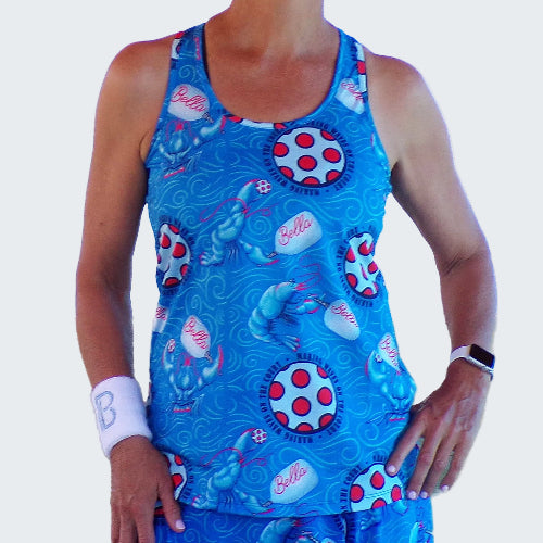Person wearing a blue tank top with polka dot and cartoon character patterns on a white background