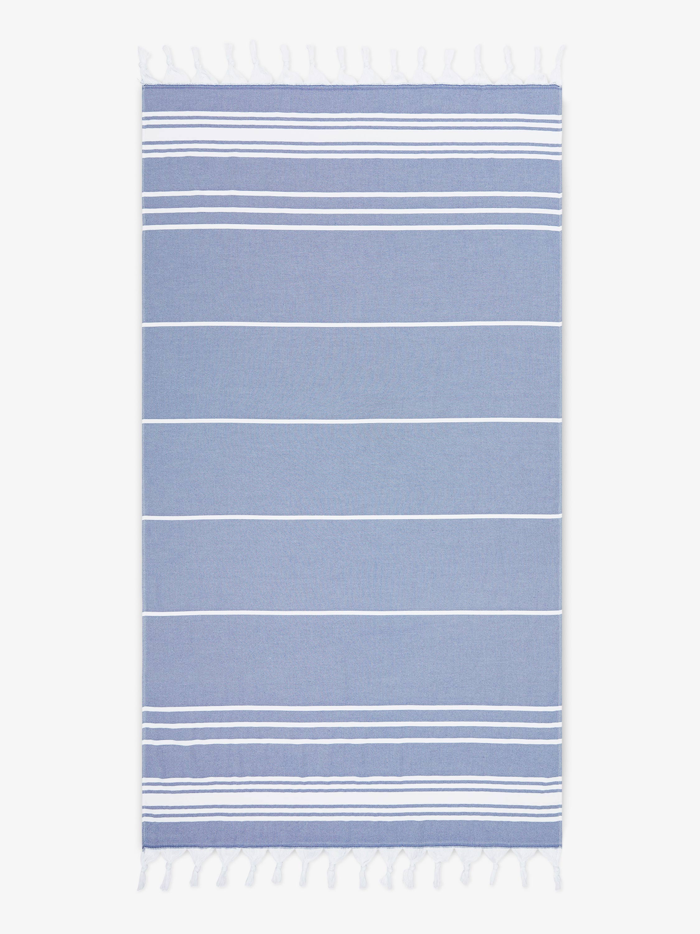 Blue and white striped towel with tassels on a white background