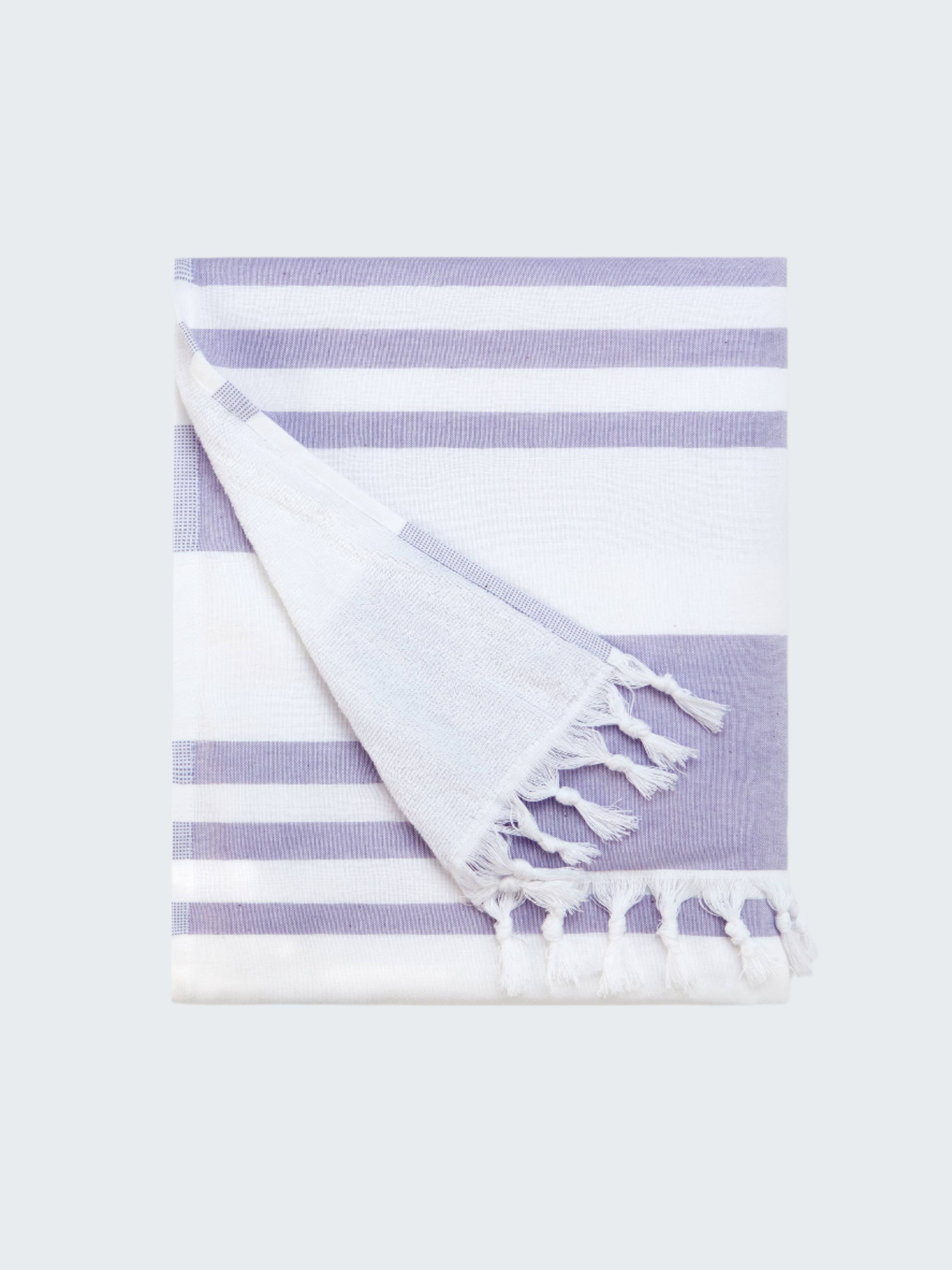 Striped towel with tassels on a white background