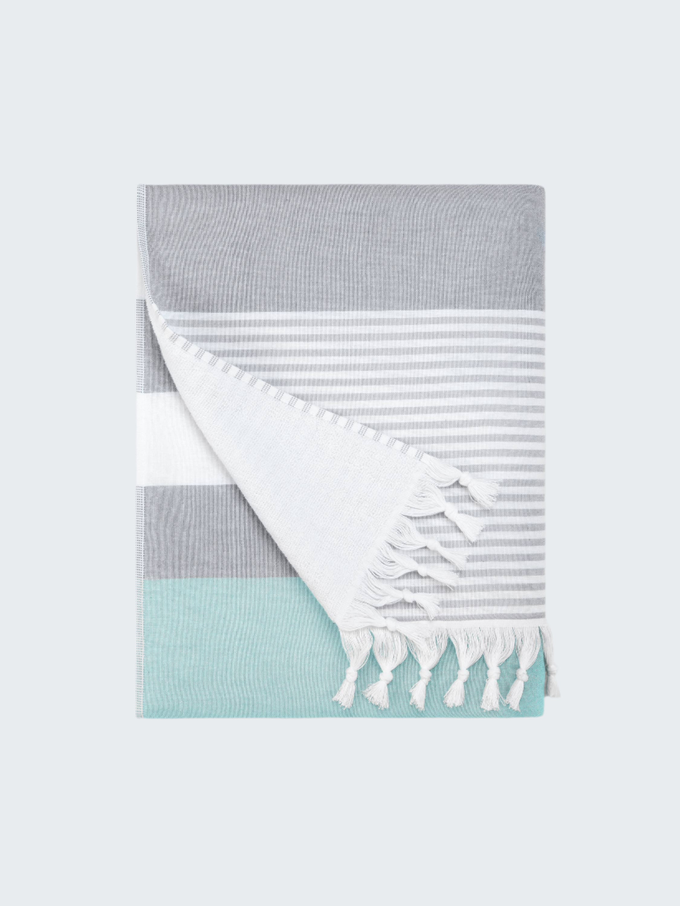 Folded towel with gray, white, and light blue stripes on a white background