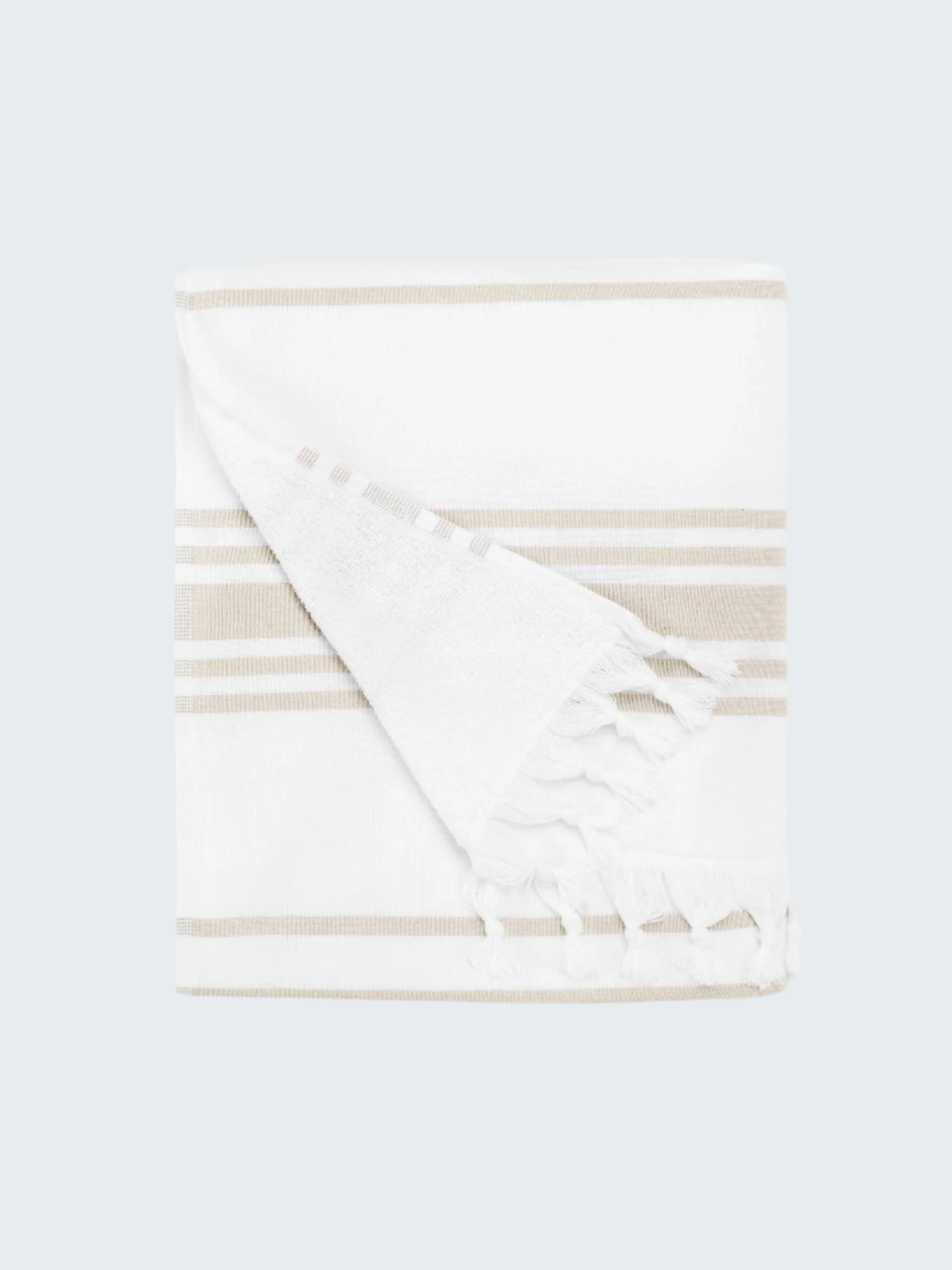 Folded white blanket with beige stripes on a white background