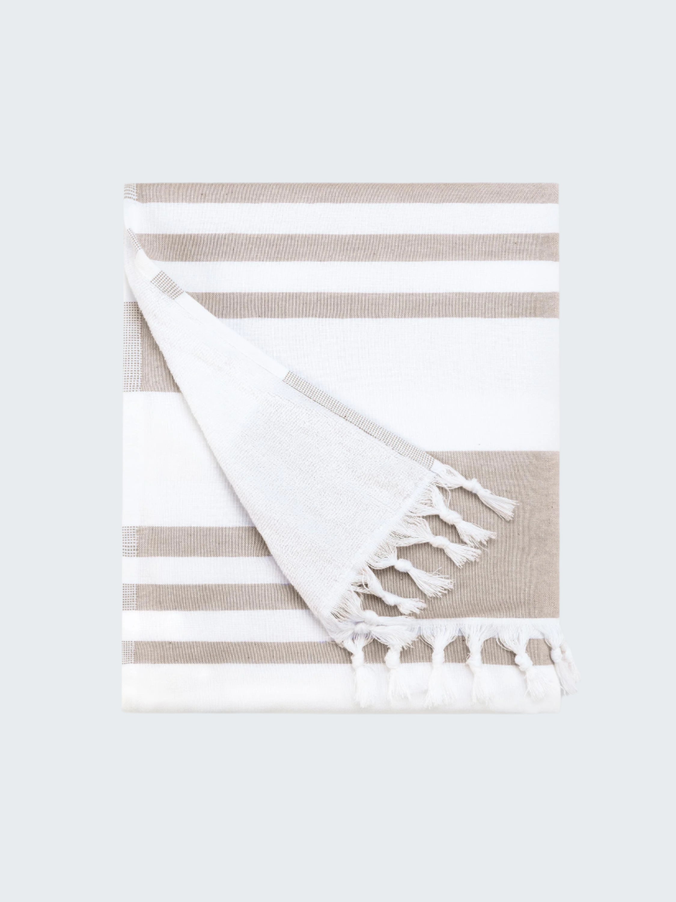 Striped towel with tassels on a white background