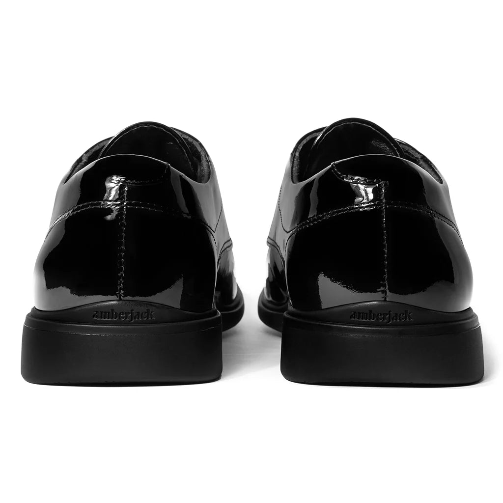 Black patent leather shoes on a white background