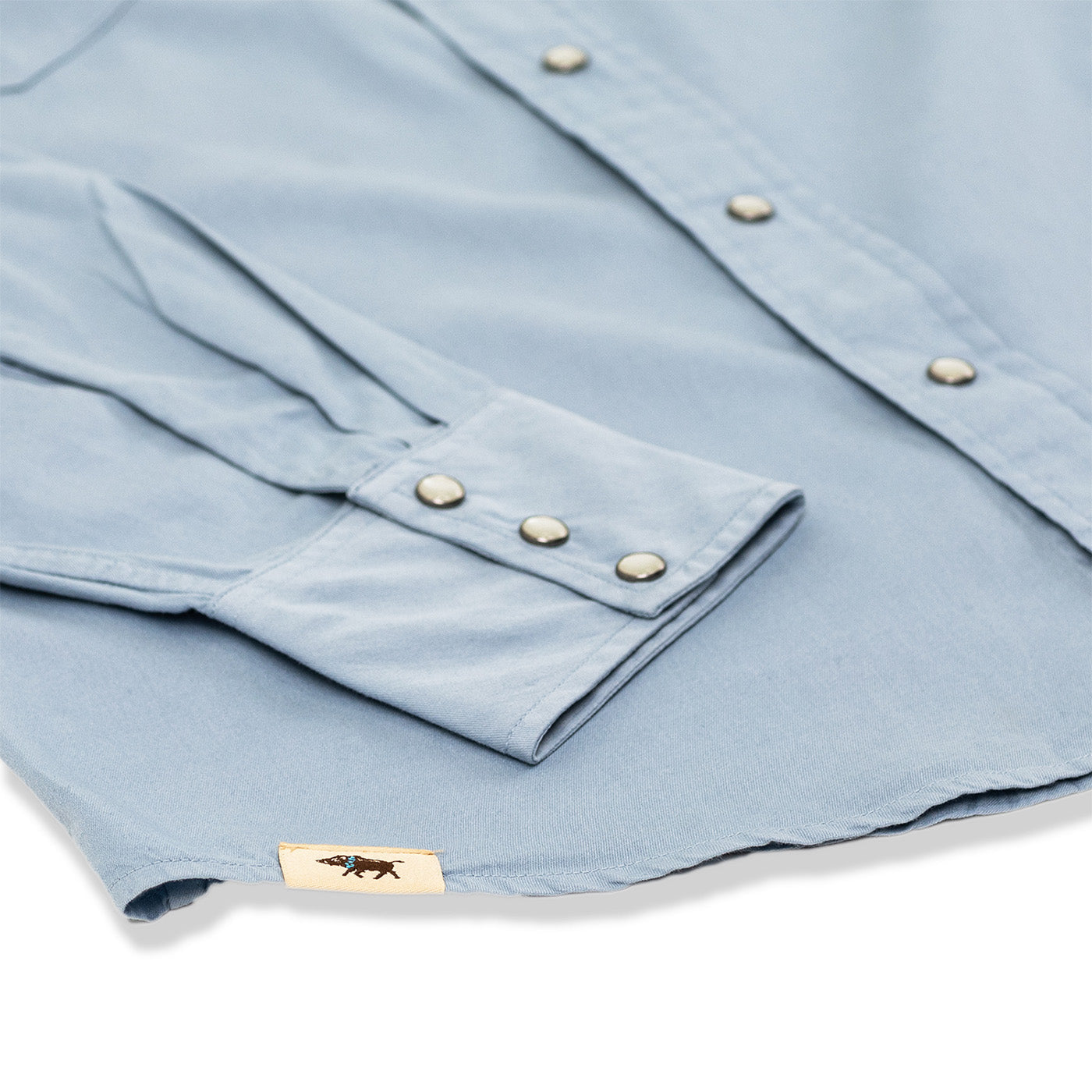 Light blue shirt with buttons on a white background