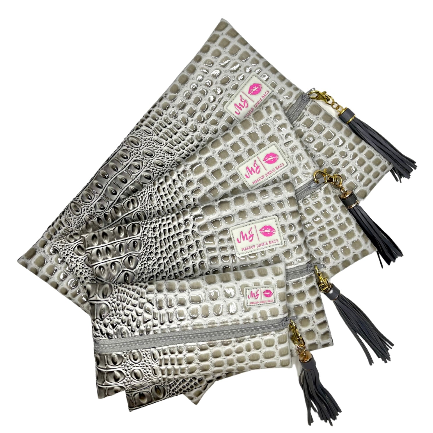 Three patterned bags with tassels on a white background