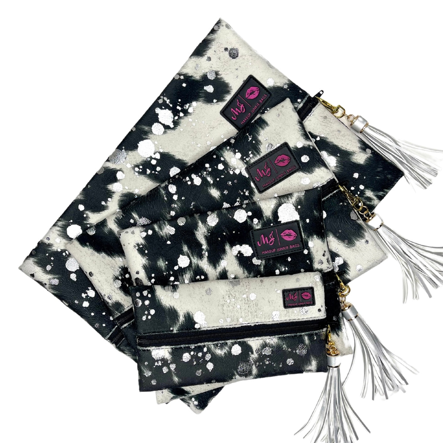 Black and white patterned pouches with tassels and visible branding on a white background