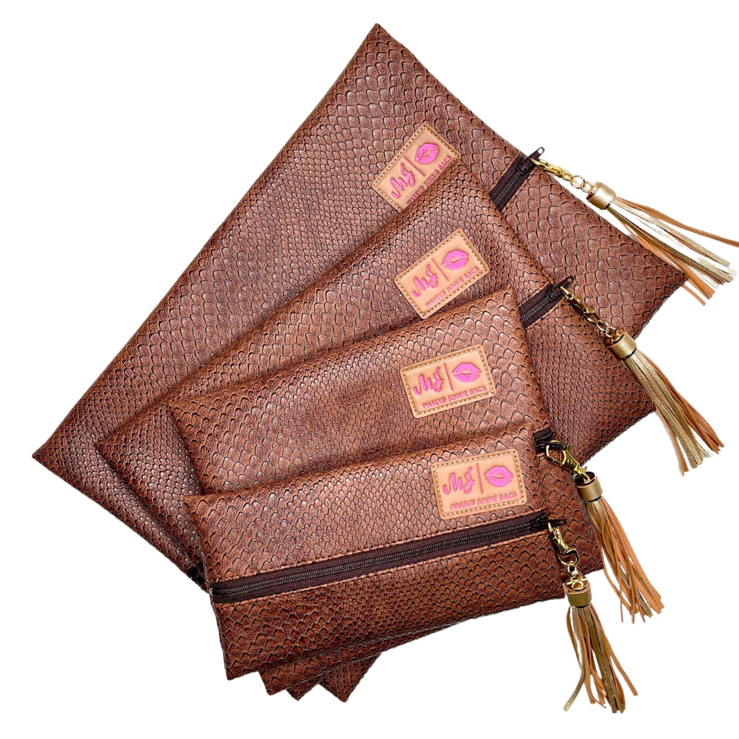 Set of brown leather pouches with tassels on a white background