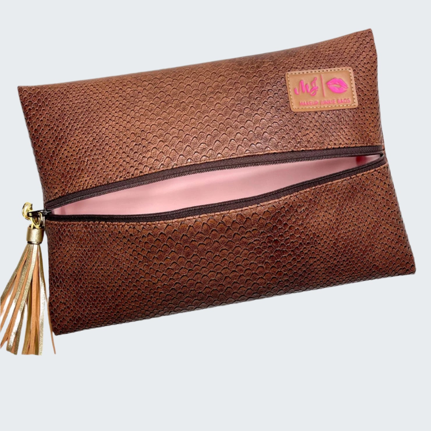 Brown clutch bag with a tassel on a white background