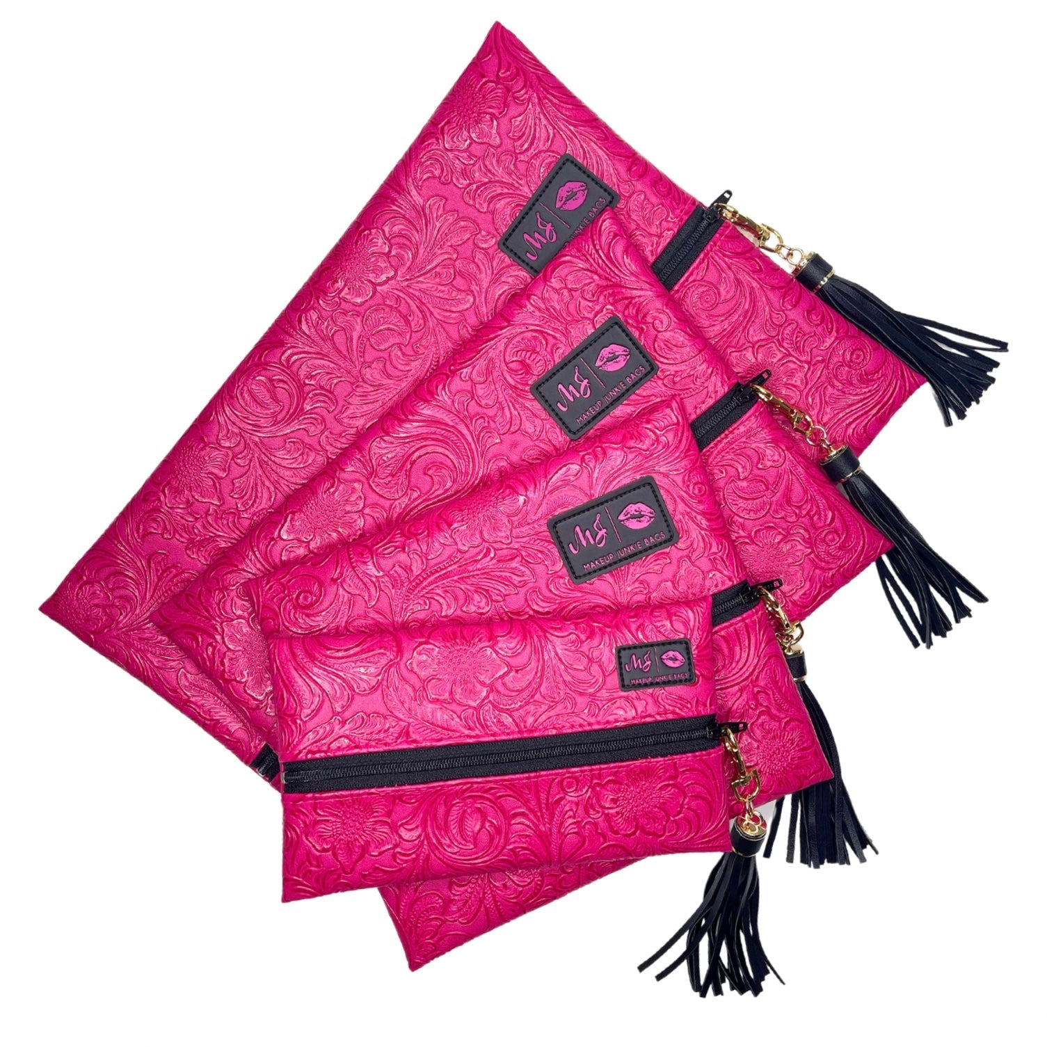 Set of pink pouches with black tassels and decorative labels on a white background