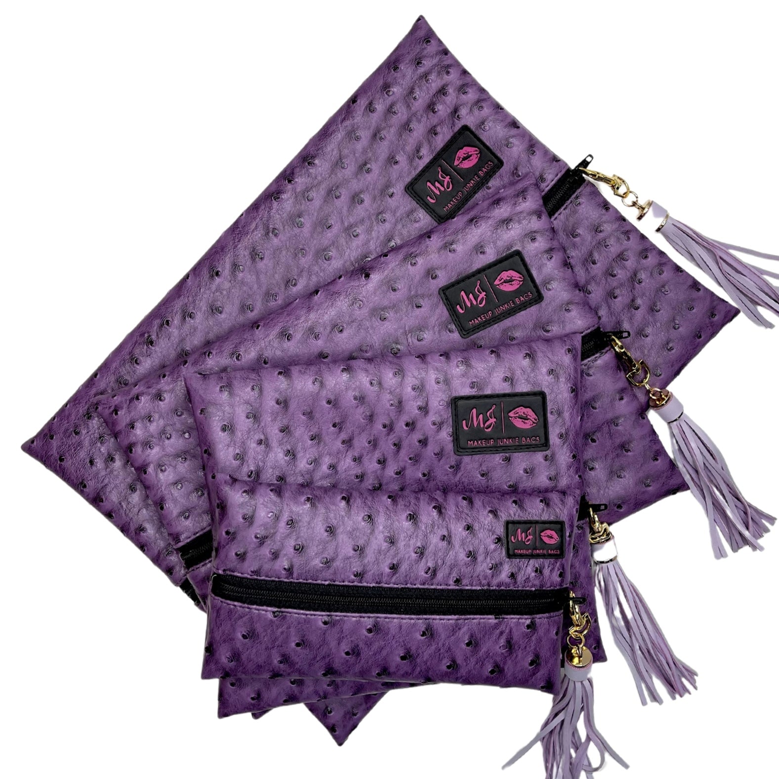 Purple patterned bags with tassels and visible brand logo on a white background