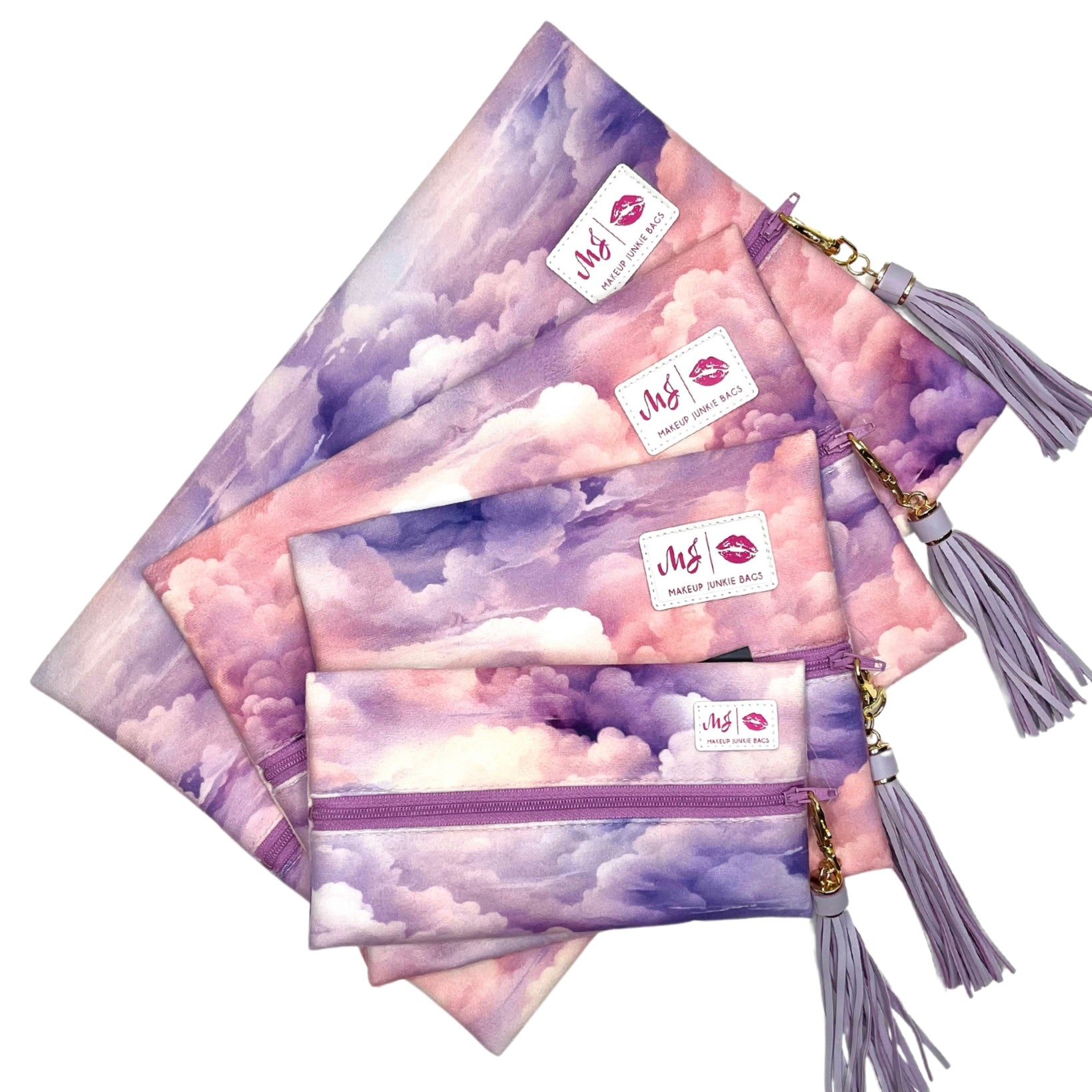 Set of cloud-patterned pouches with tassels and visible brand logo on a white background