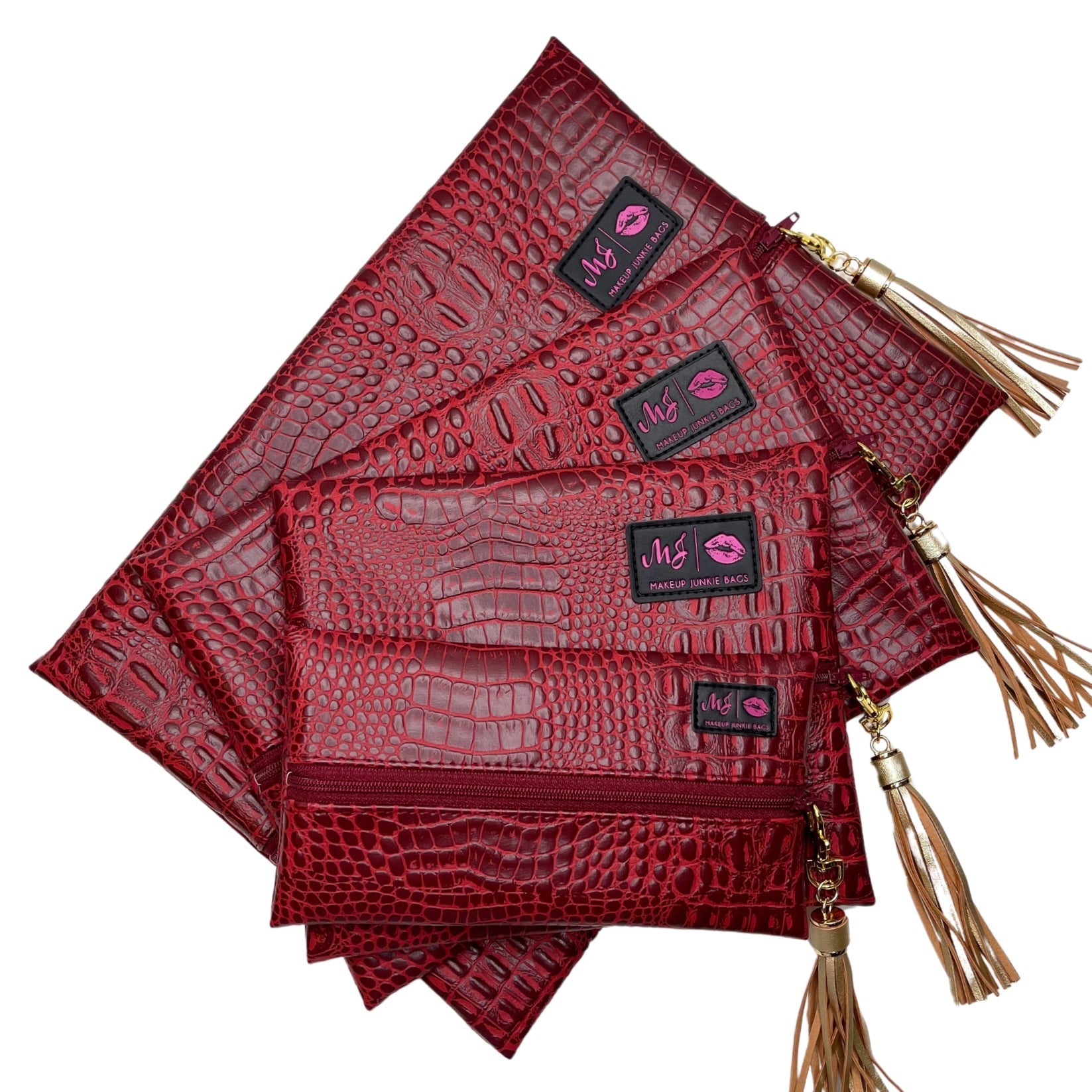 Set of red textured pouches with tassels on a white background