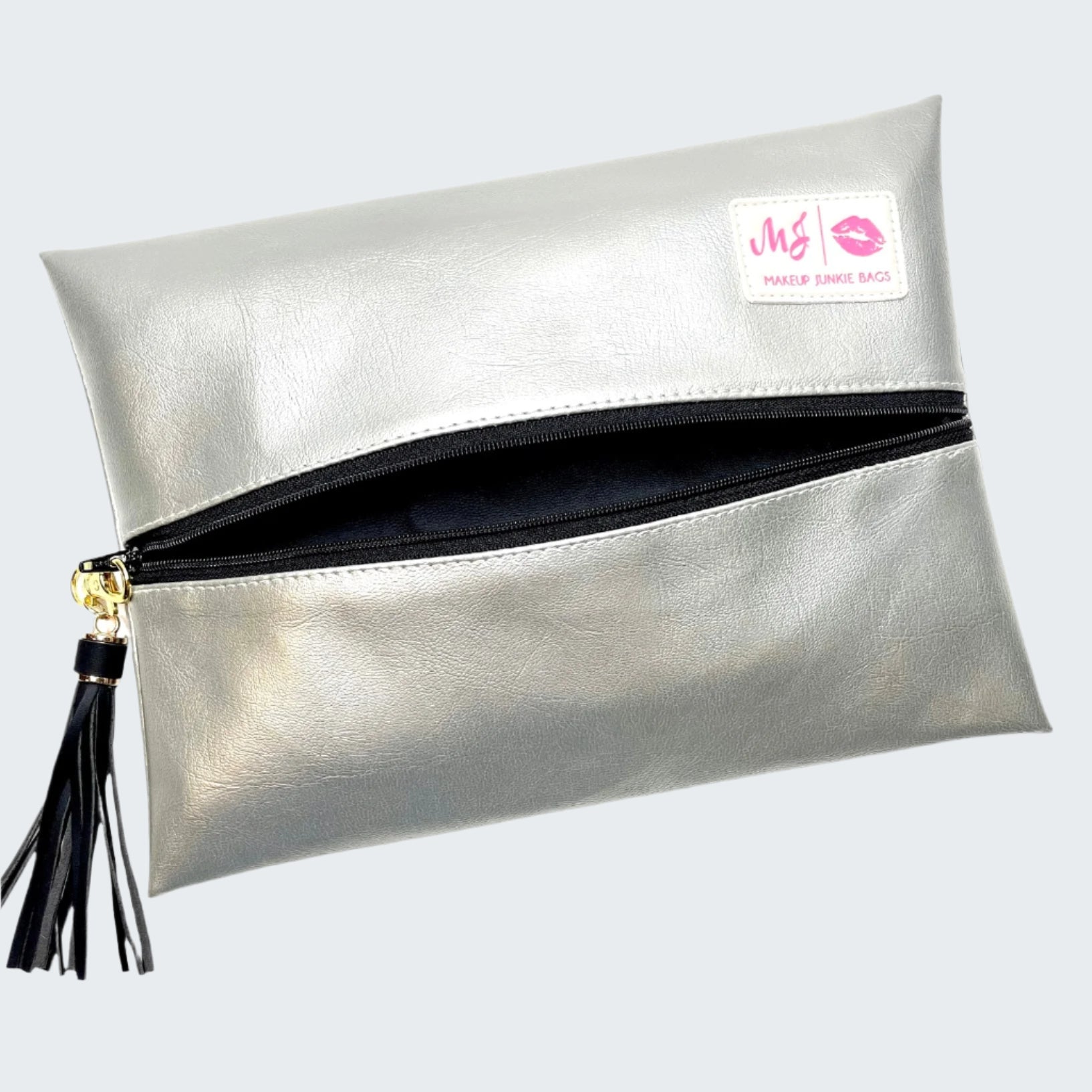 Silver clutch bag with a tassel on a white background