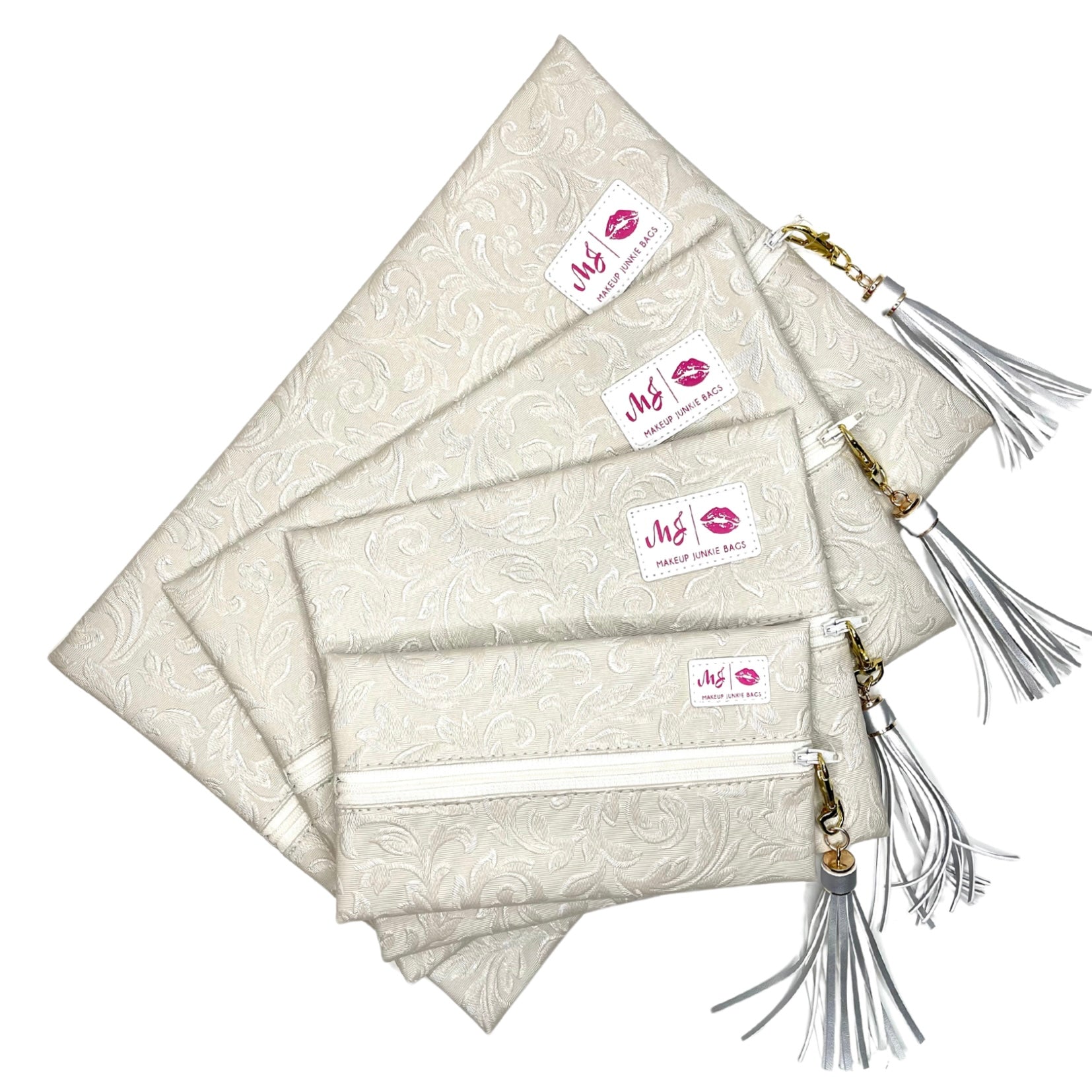 Set of beige pouches with tassels and visible branding on a white background