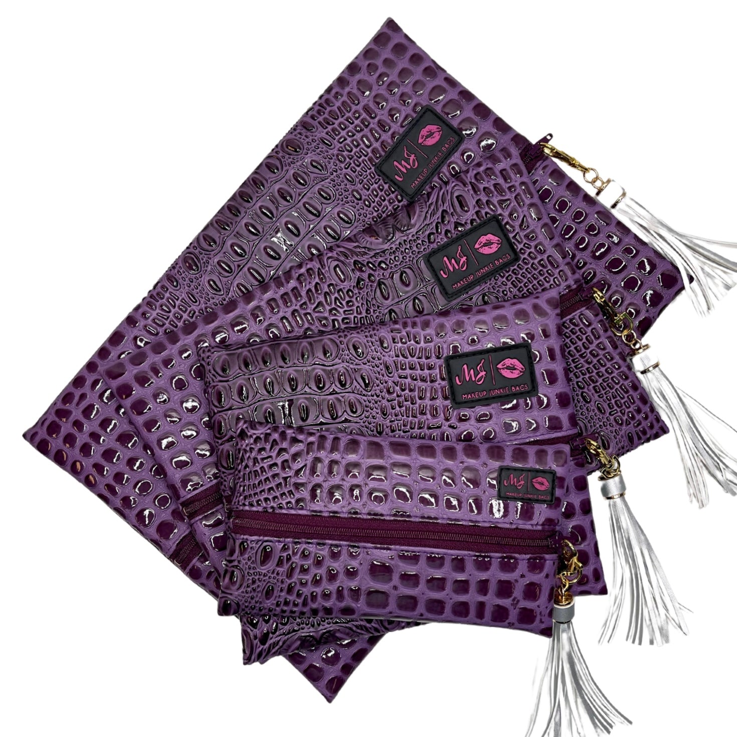 Purple textured clutch bags with tassels on a white background