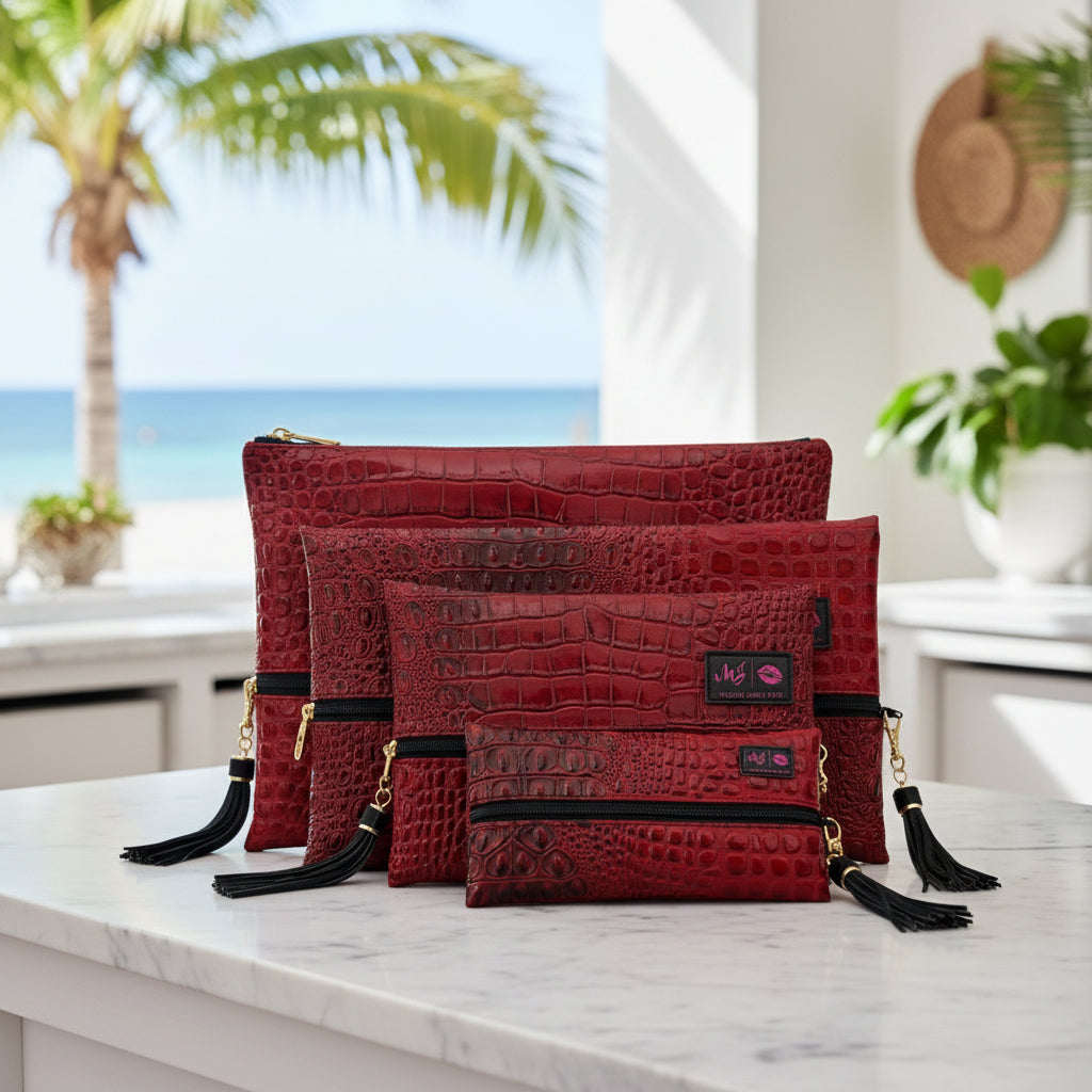 Red textured handbags with black tassels and visible brand labels on a white background