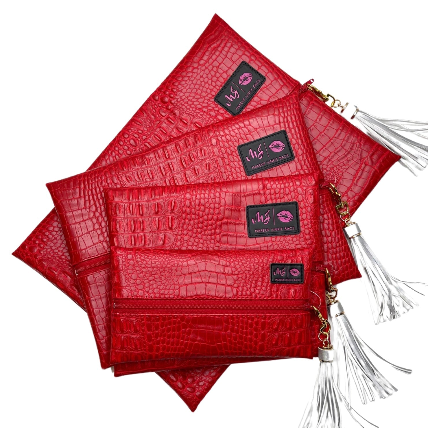 Red textured clutch bags with tassels on a white background
