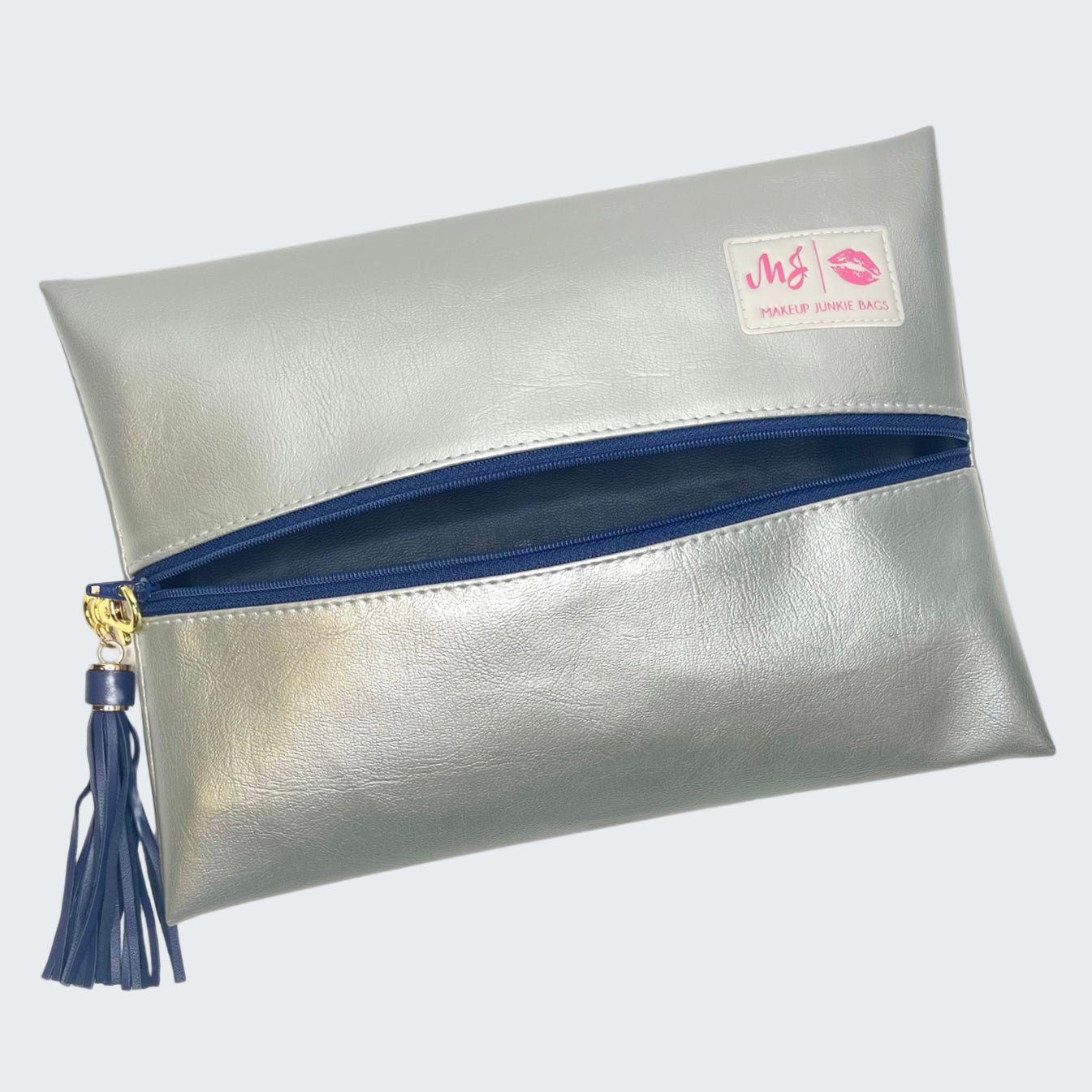Silver clutch bag with blue zipper and tassel on a white background