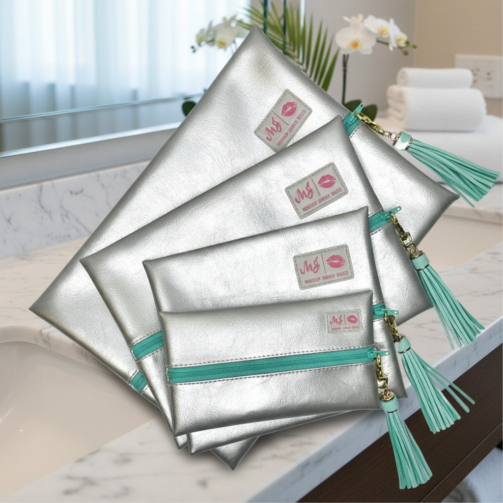Set of silver pouches with turquoise accents and tassels on a white background