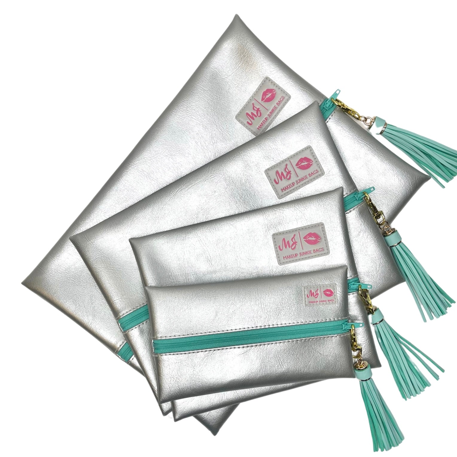 Set of silver pouches with turquoise accents and tassels on a white background