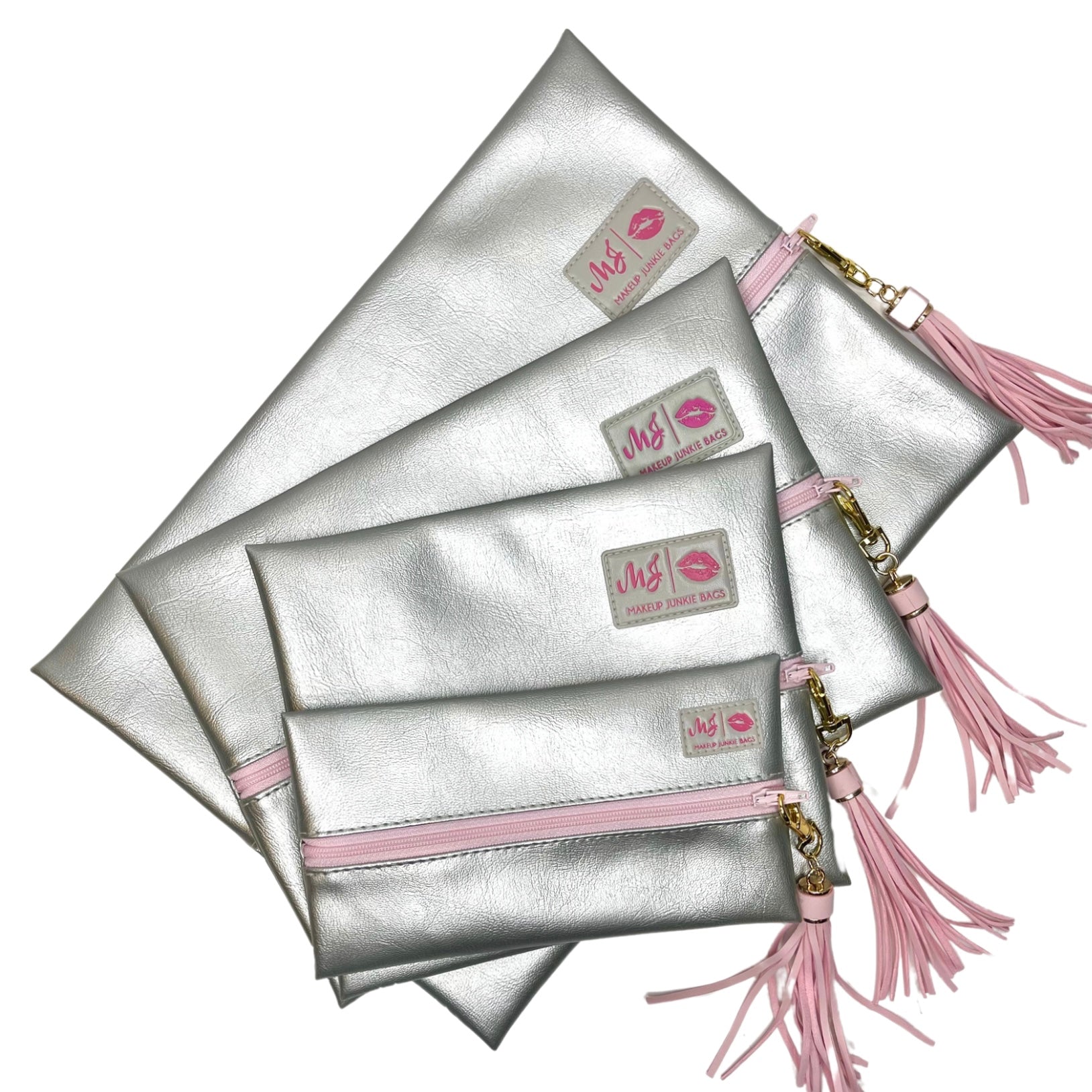 Set of silver pouches with pink accents and tassels on a white background