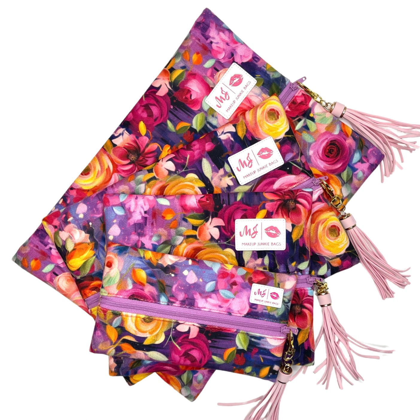 Colorful floral-patterned bags with pink tassels and visible brand labels on a white background