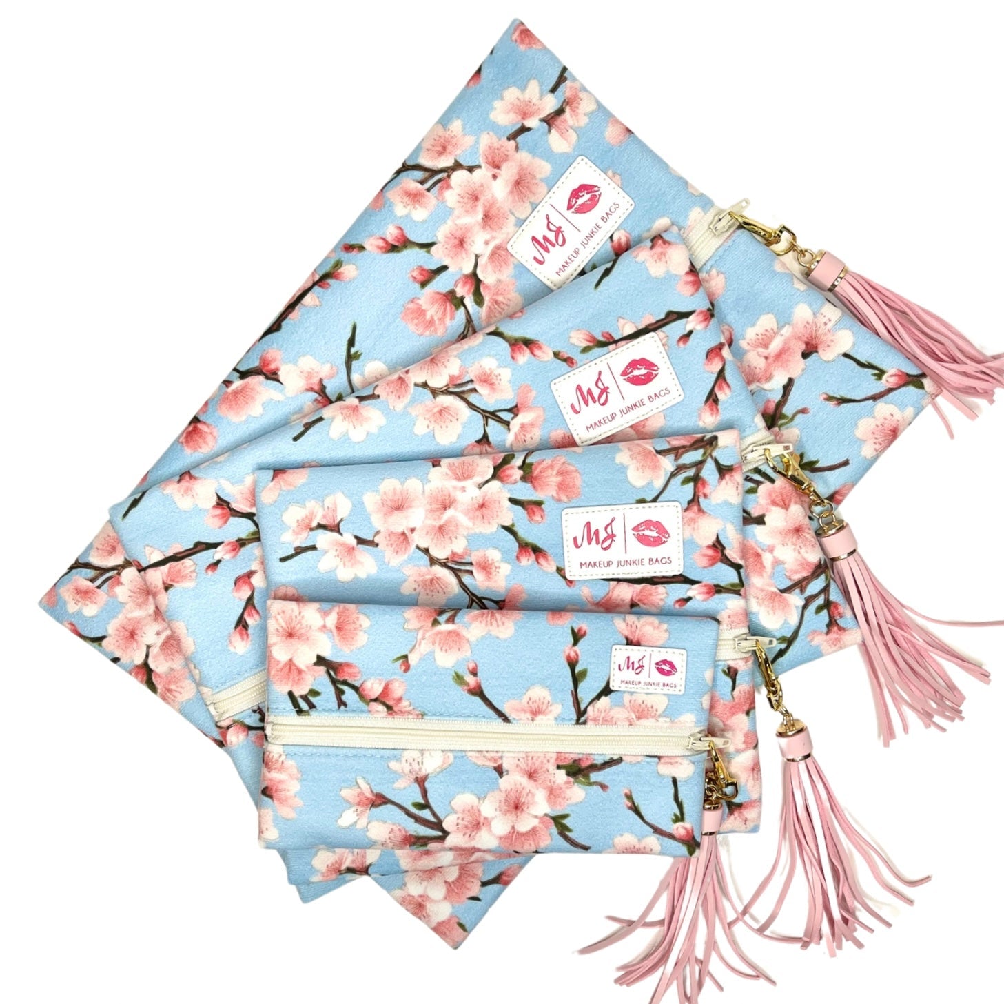 Set of cherry blossom-themed pouches with tassels on a white background