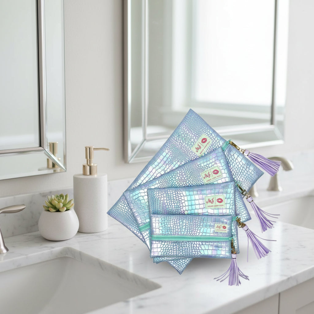 Set of holographic makeup bags with tassels on a white background