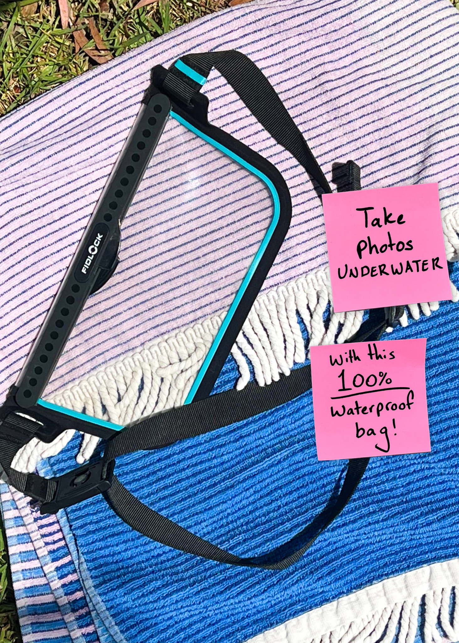 Black waterproof bag with a pink sticky note on a towel